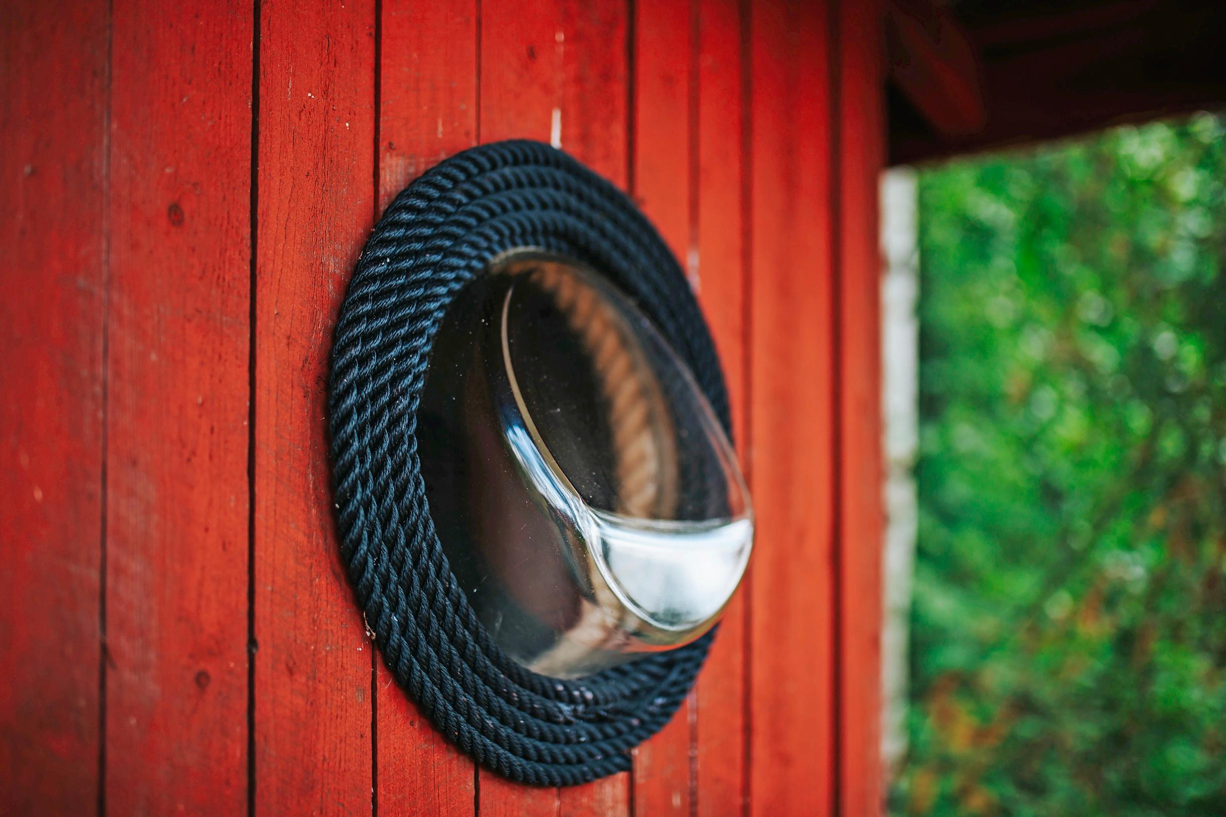 A washing machine door used as the outhouse's window