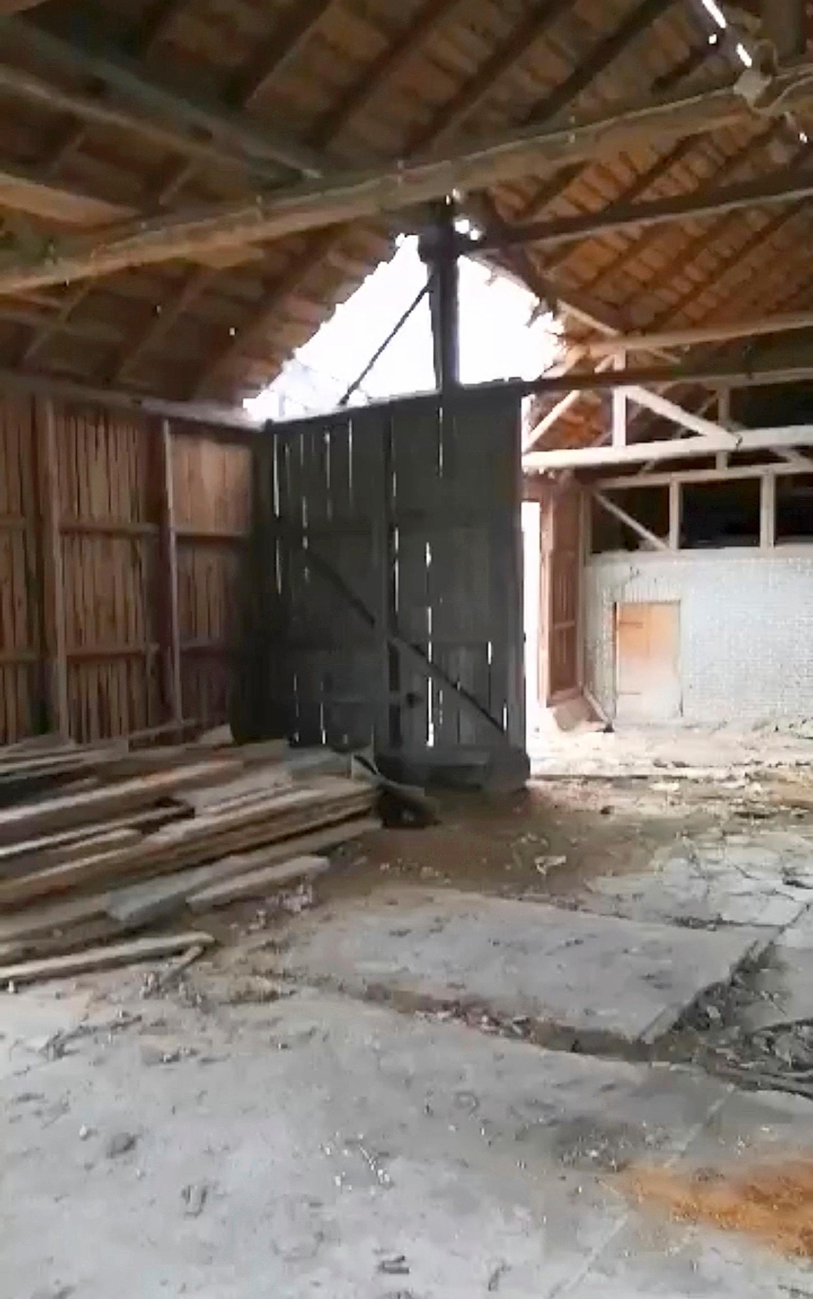 The barn’s concrete floor and log walls.