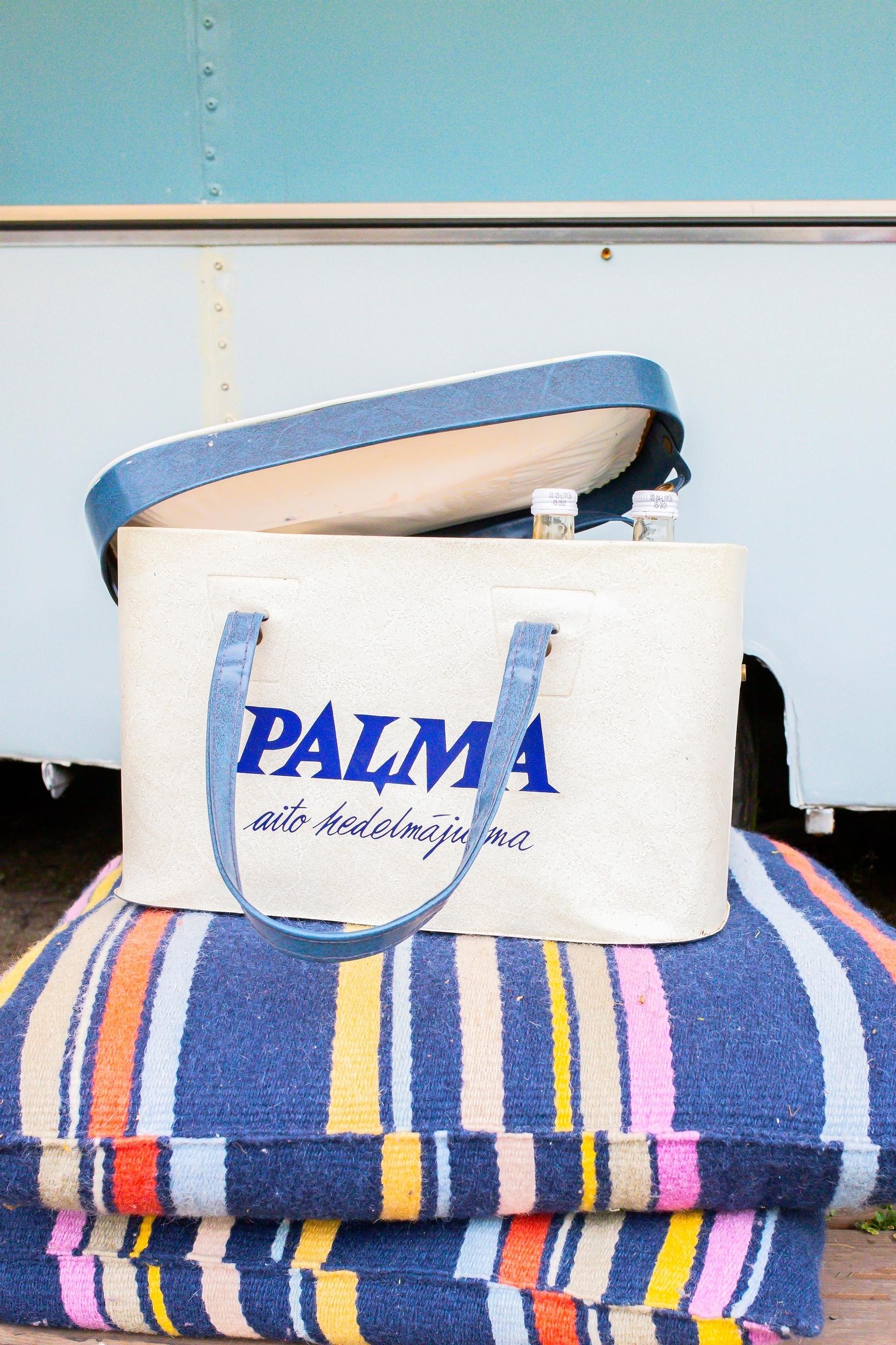 An old cooler on top of garden chair cushions