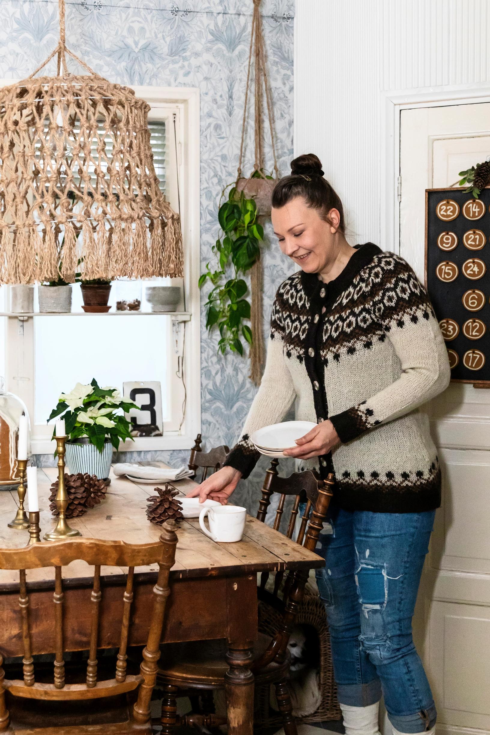 Maria Meder setting the table in her kitchen