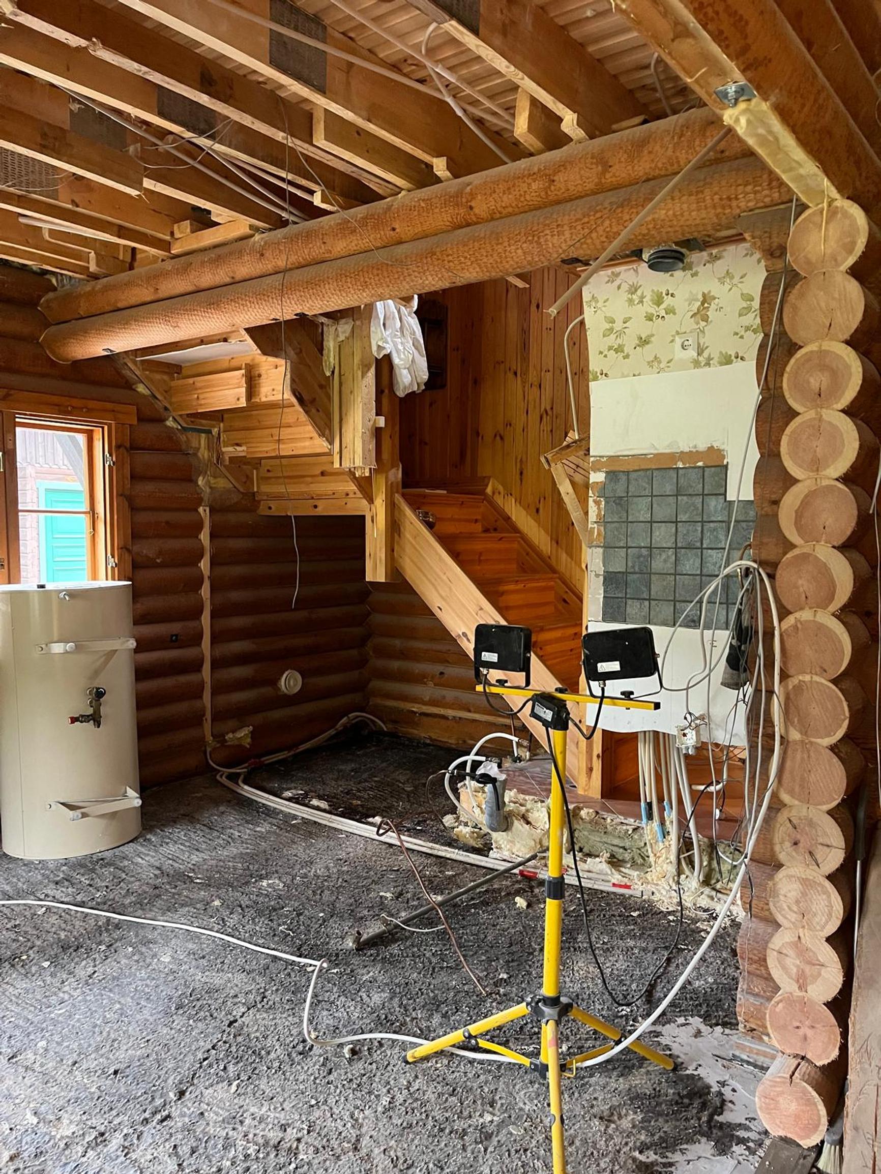 The old staircase in the log house leading upstairs.