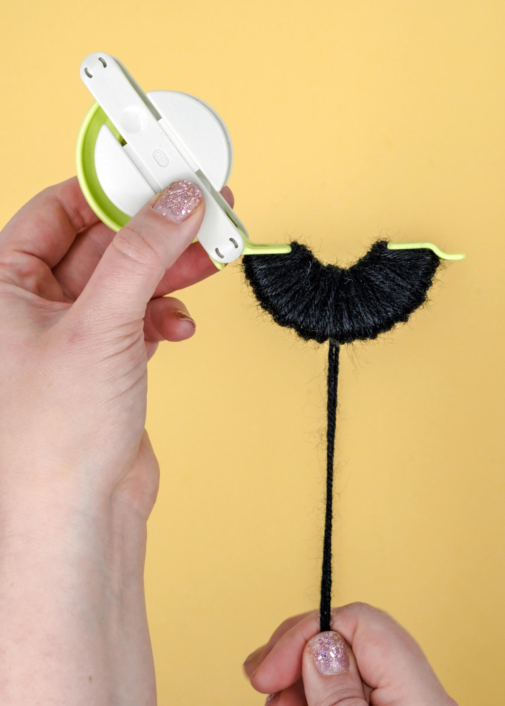 making a pompom with a pompom maker