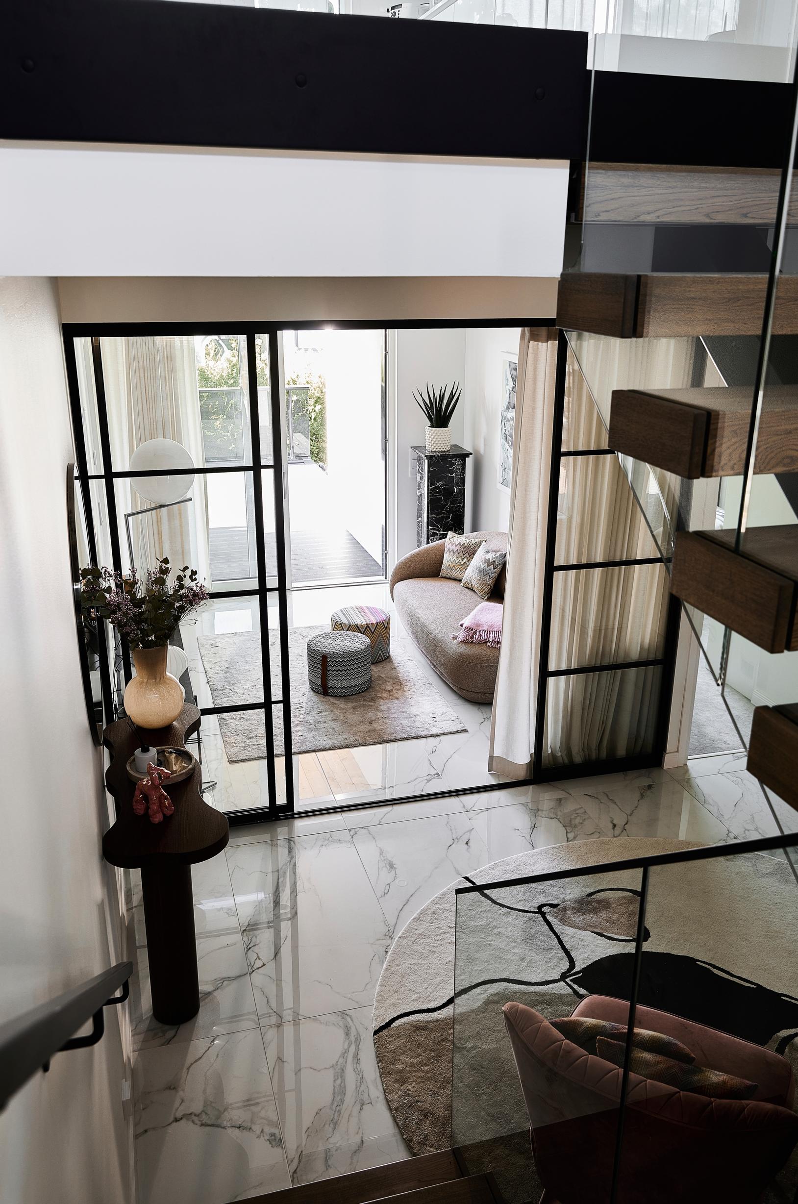 A view from the stairs into the hallway and the living room.