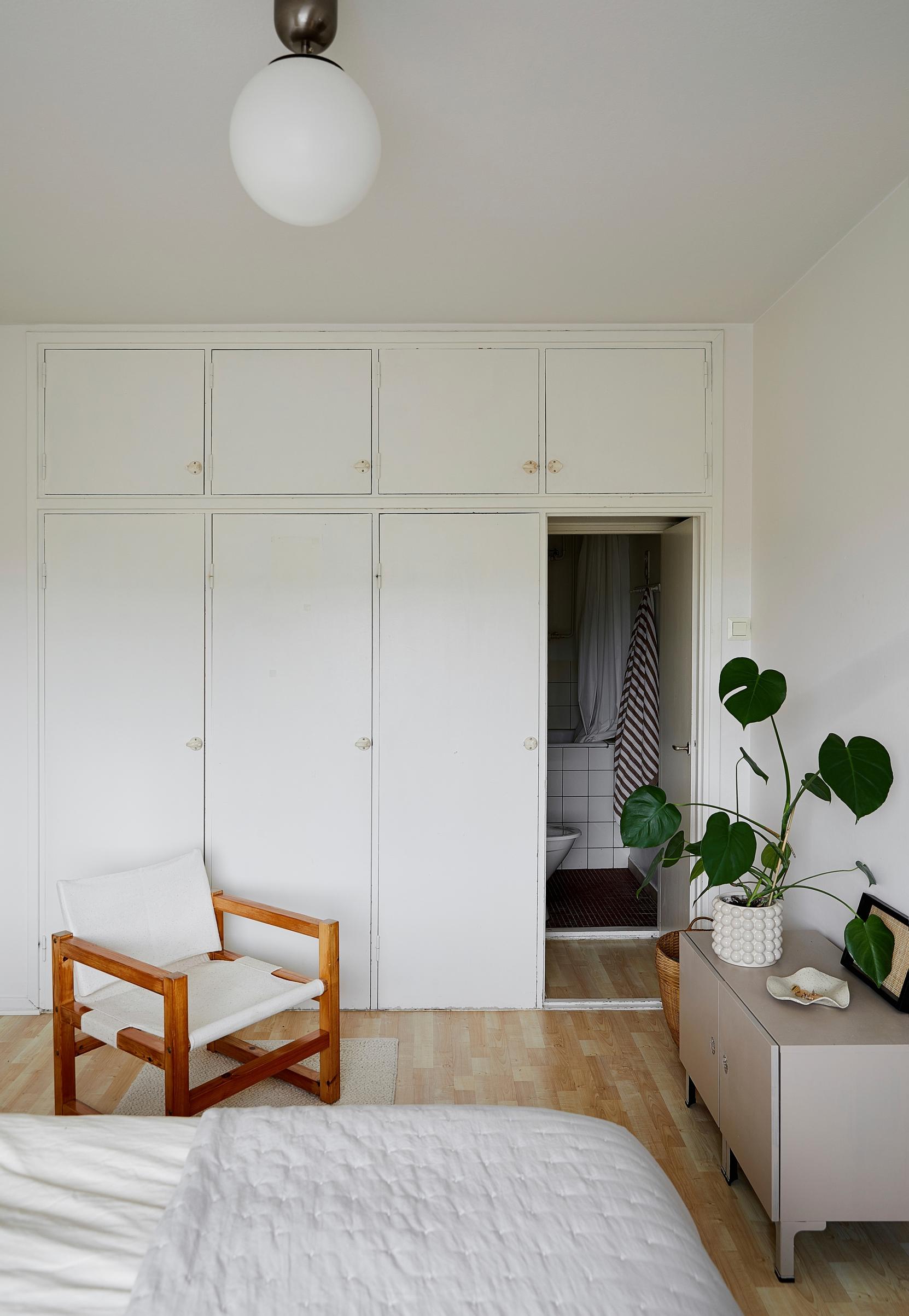 A vintage chair in the bedroom and a painted Ikea cabinet