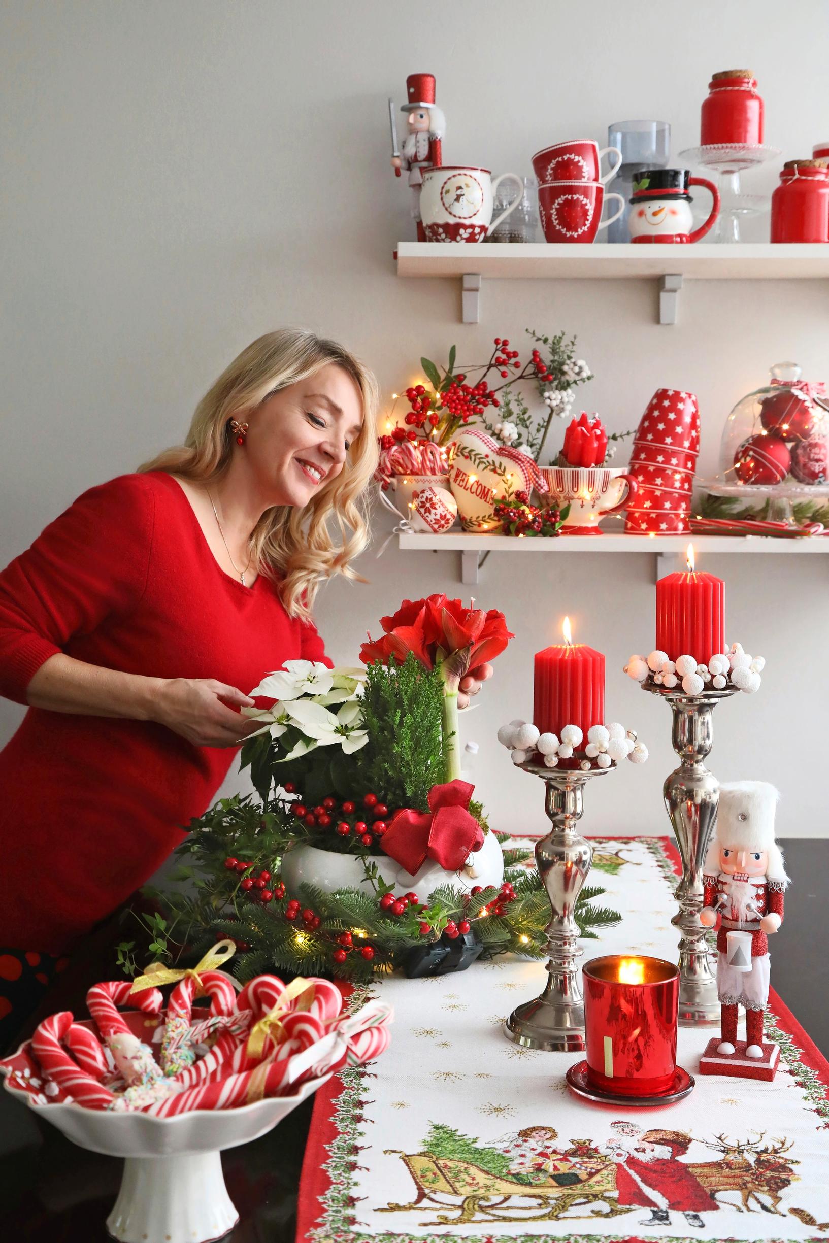 Hanna and a Christmas flower arrangement.