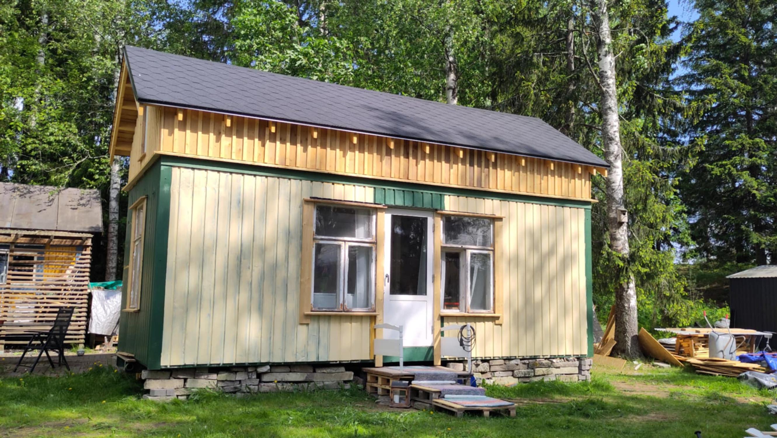 A small house renovated from a yellow-green steel container.