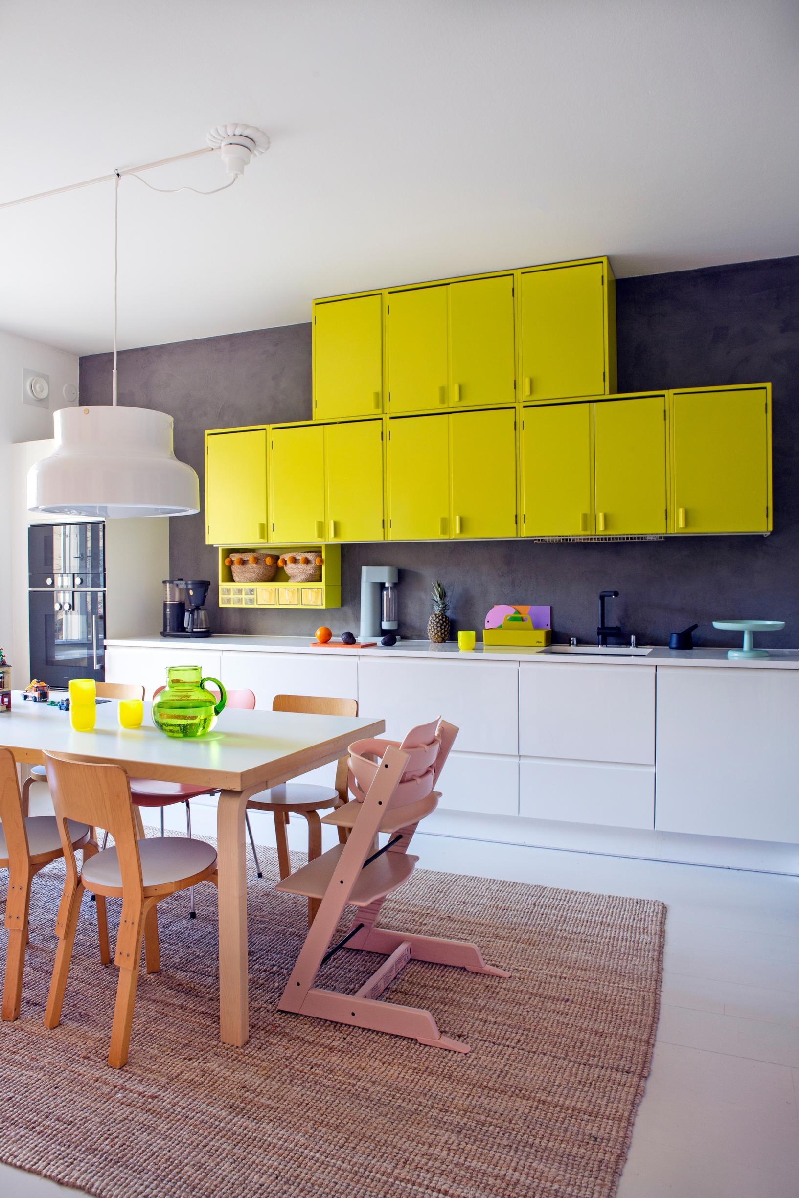 The upper kitchen cabinets are made from old solid wood cabinets and painted lemon yellow.