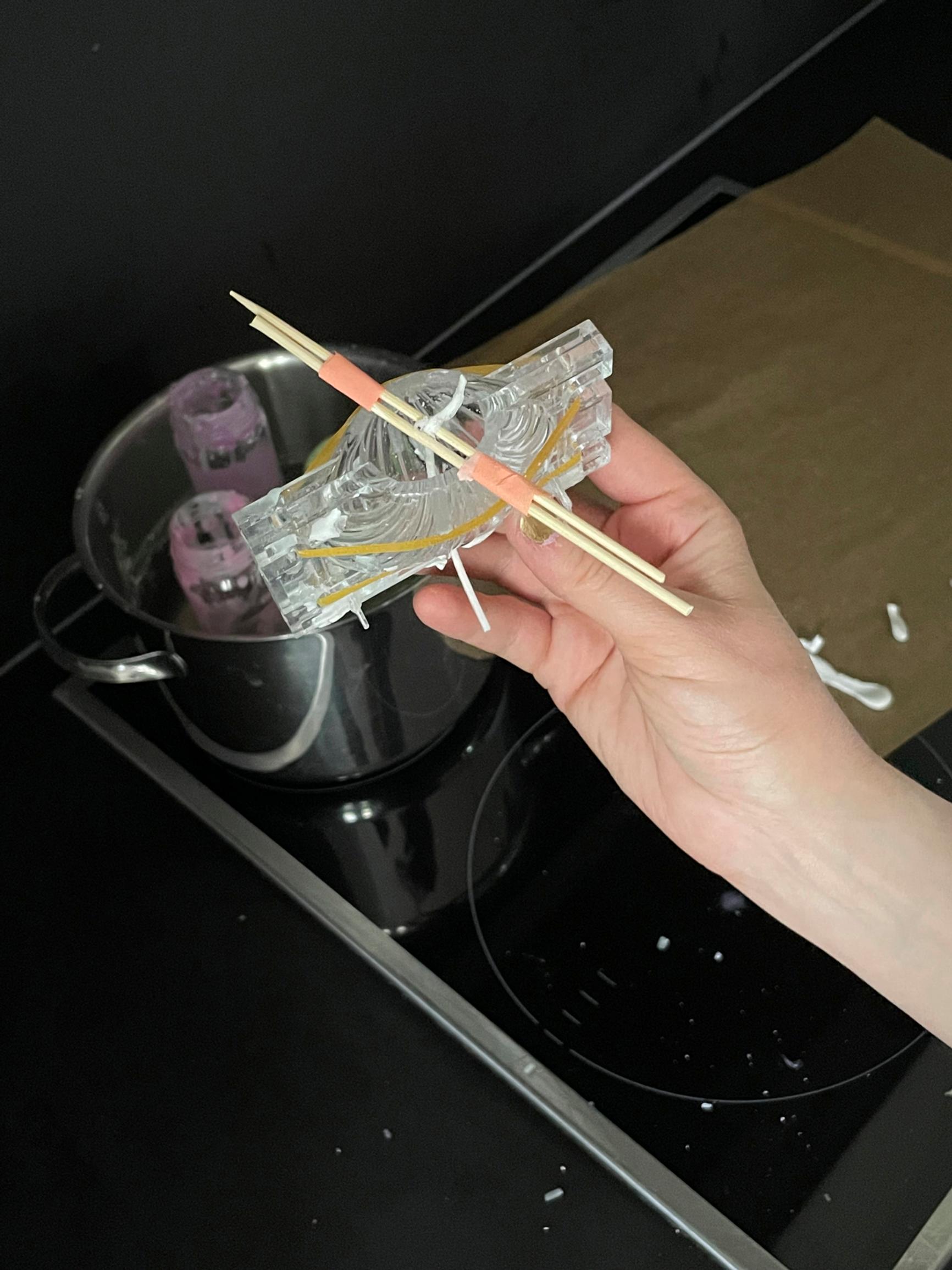 Stringing the wick in the candle mold