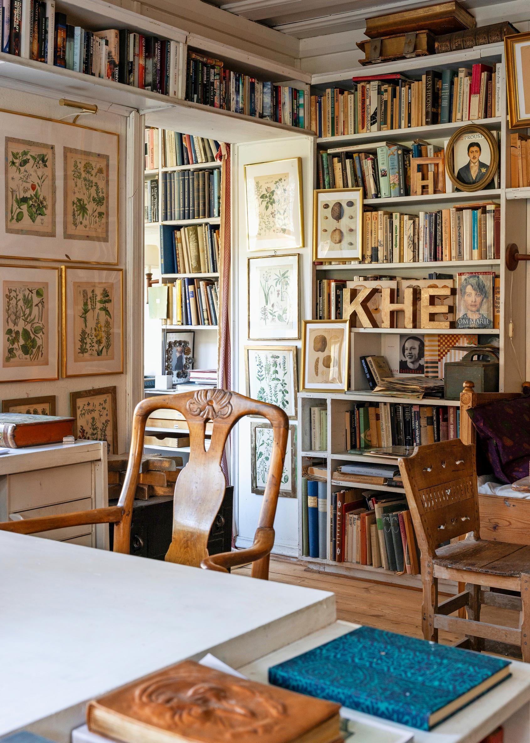 Library room with an abundance of books. A Rococo-style armchair sits in front.