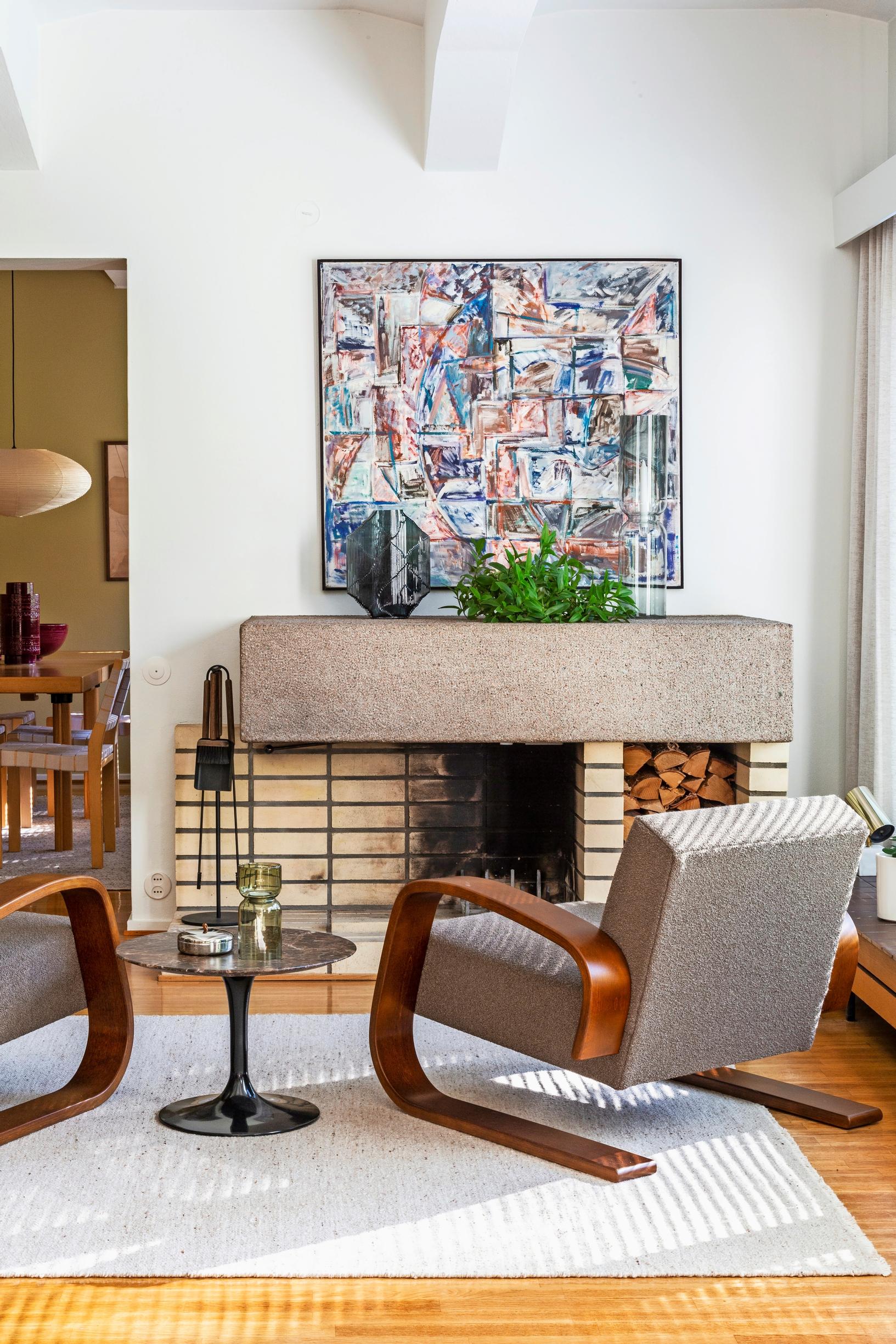 Tankki chairs in front of the brick fireplace