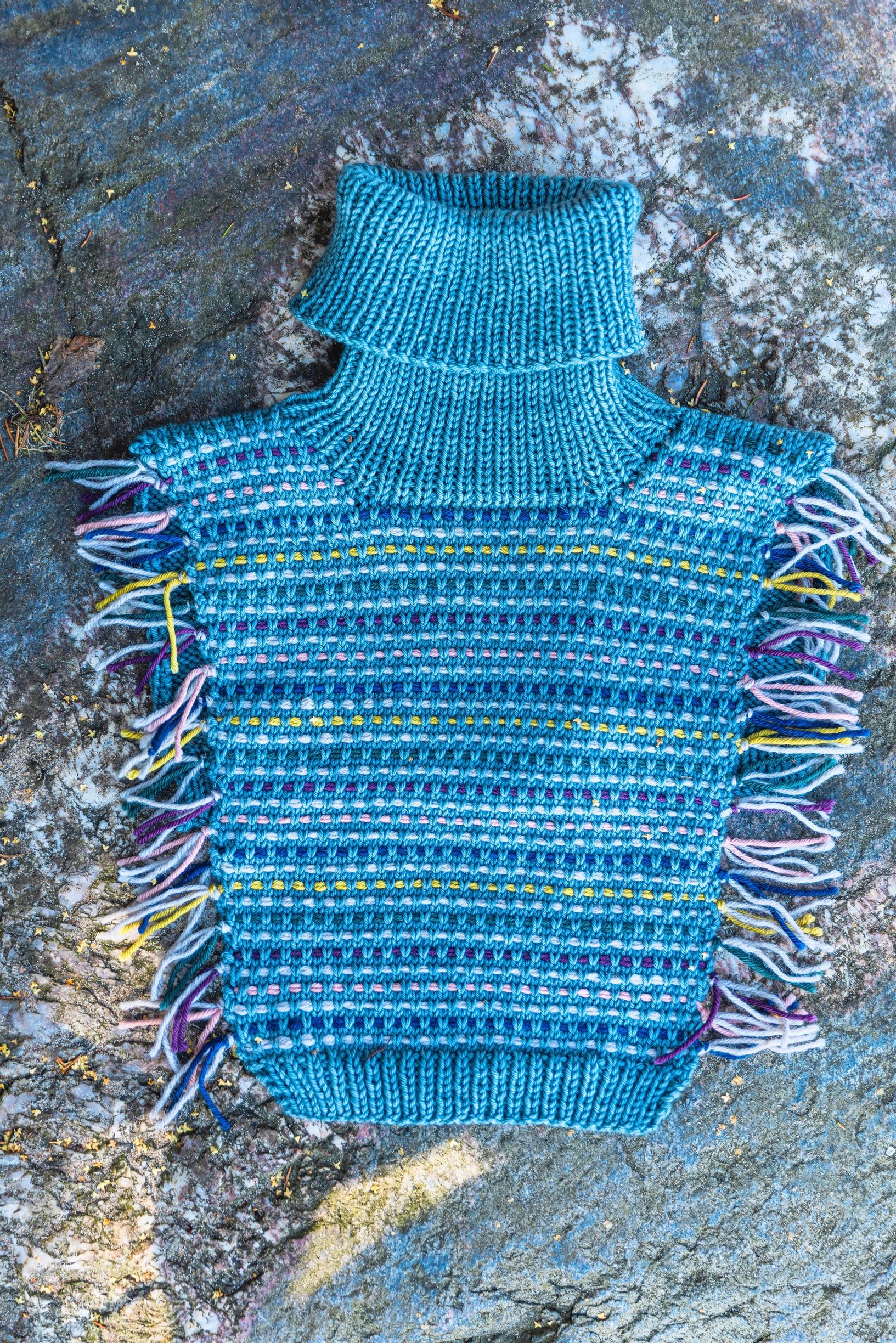Knitted leftover-yarn neck warmer on a surface
