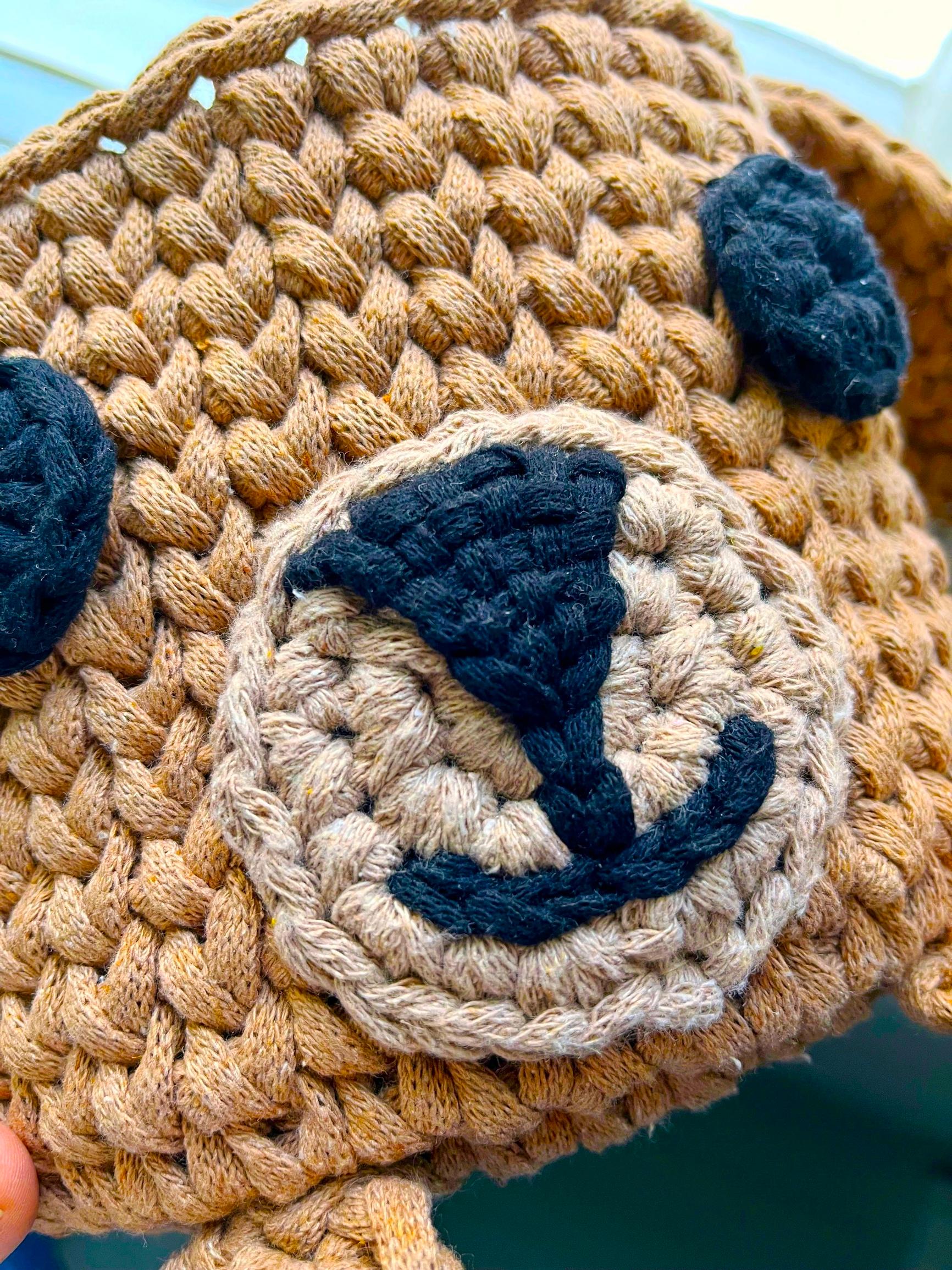 A nose and mouth embroidered on the dog basket