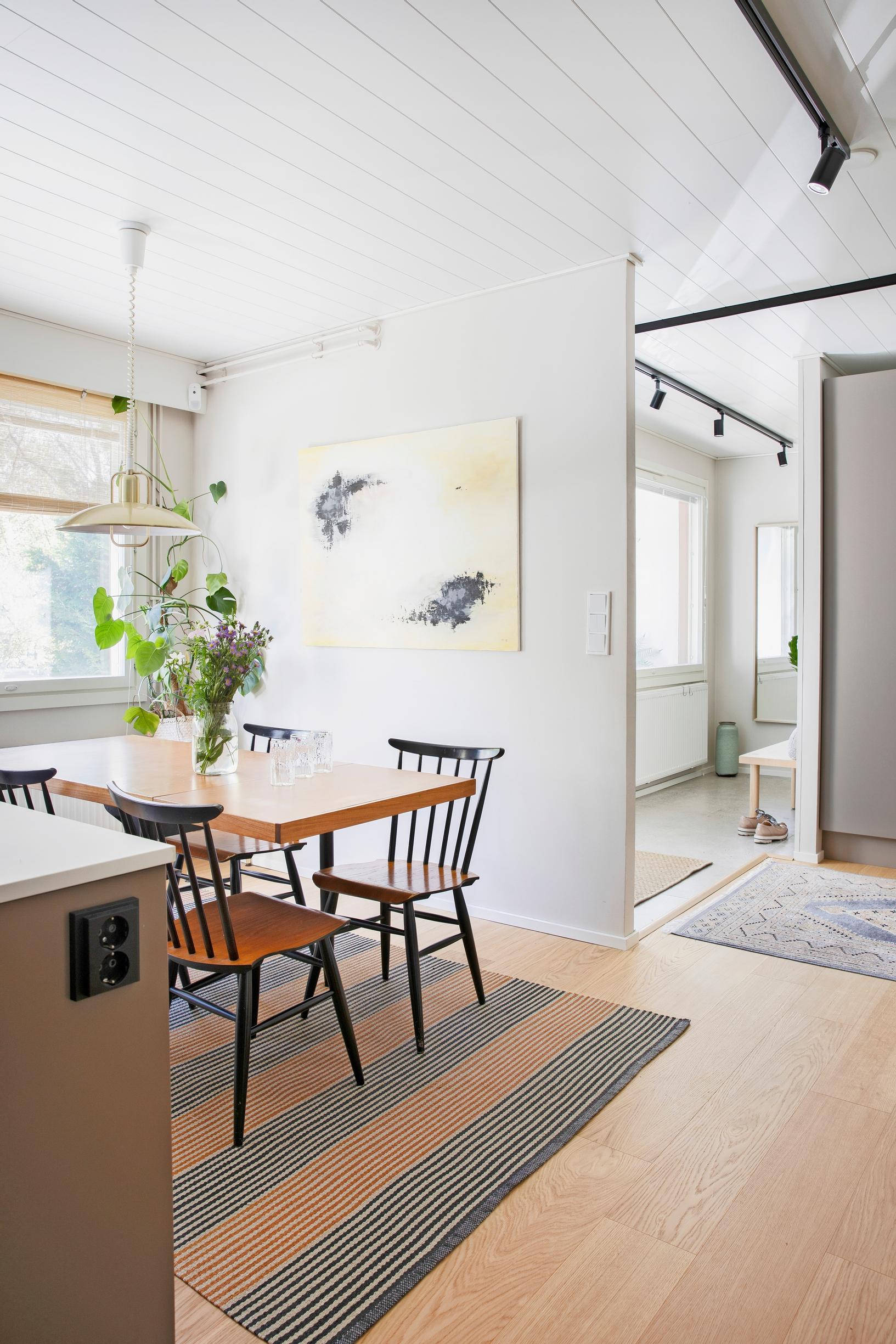 Photo of the open-plan kitchen with a thrifted dining set and spindle-back chairs.