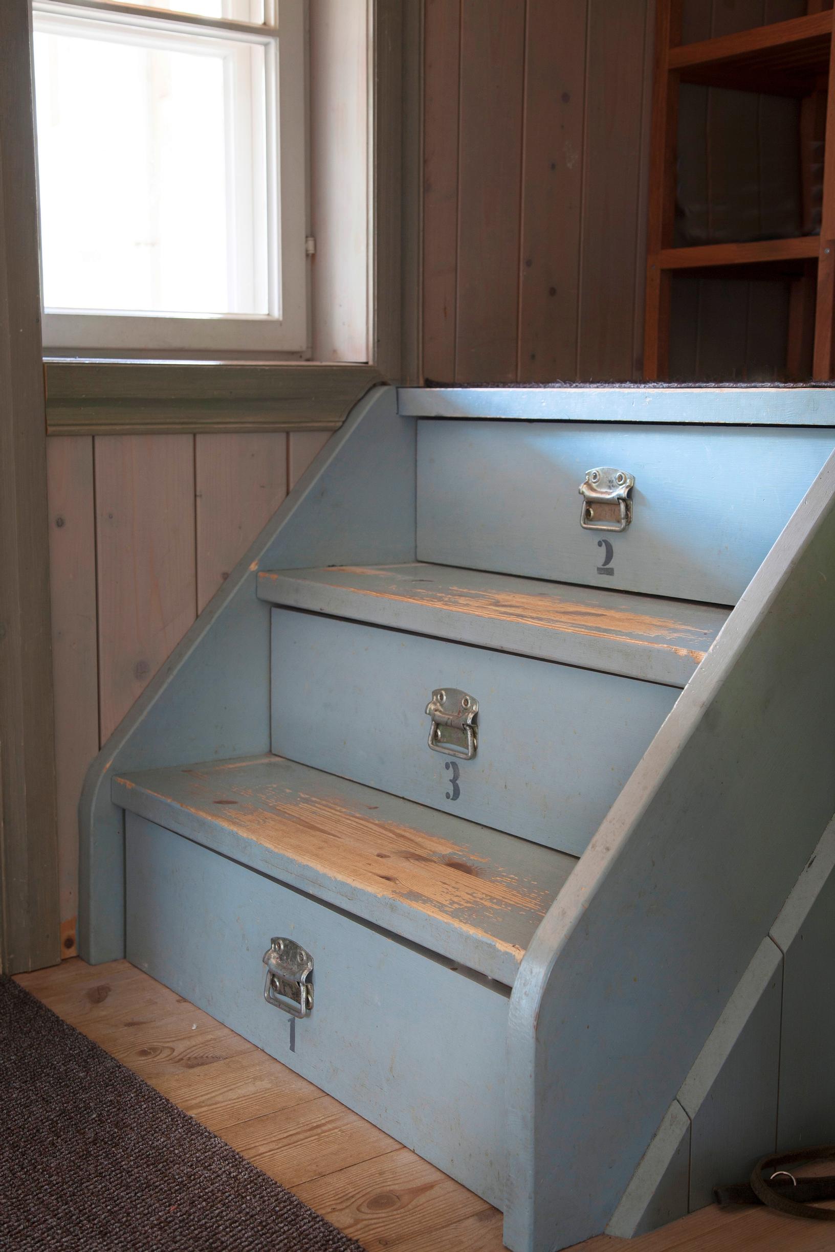 Pull-out drawers under the stairs.