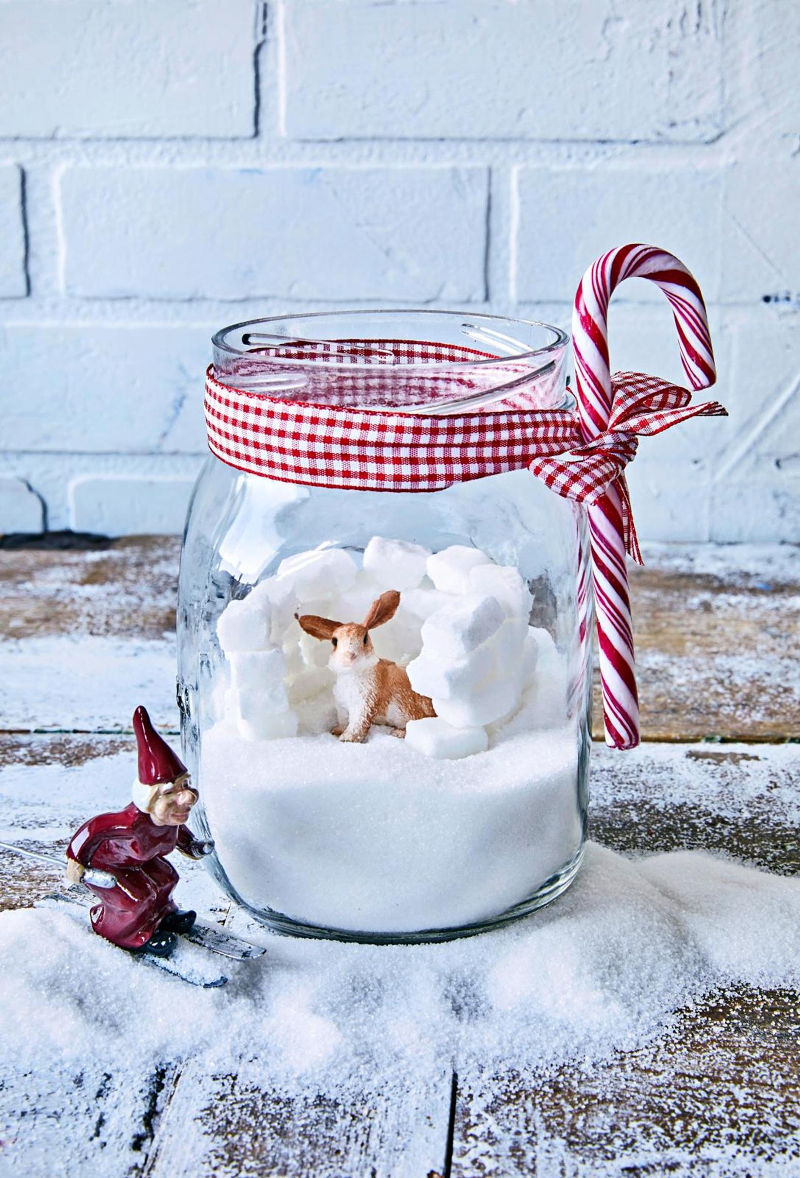 A snow castle made of sugar cubes in a glass jar