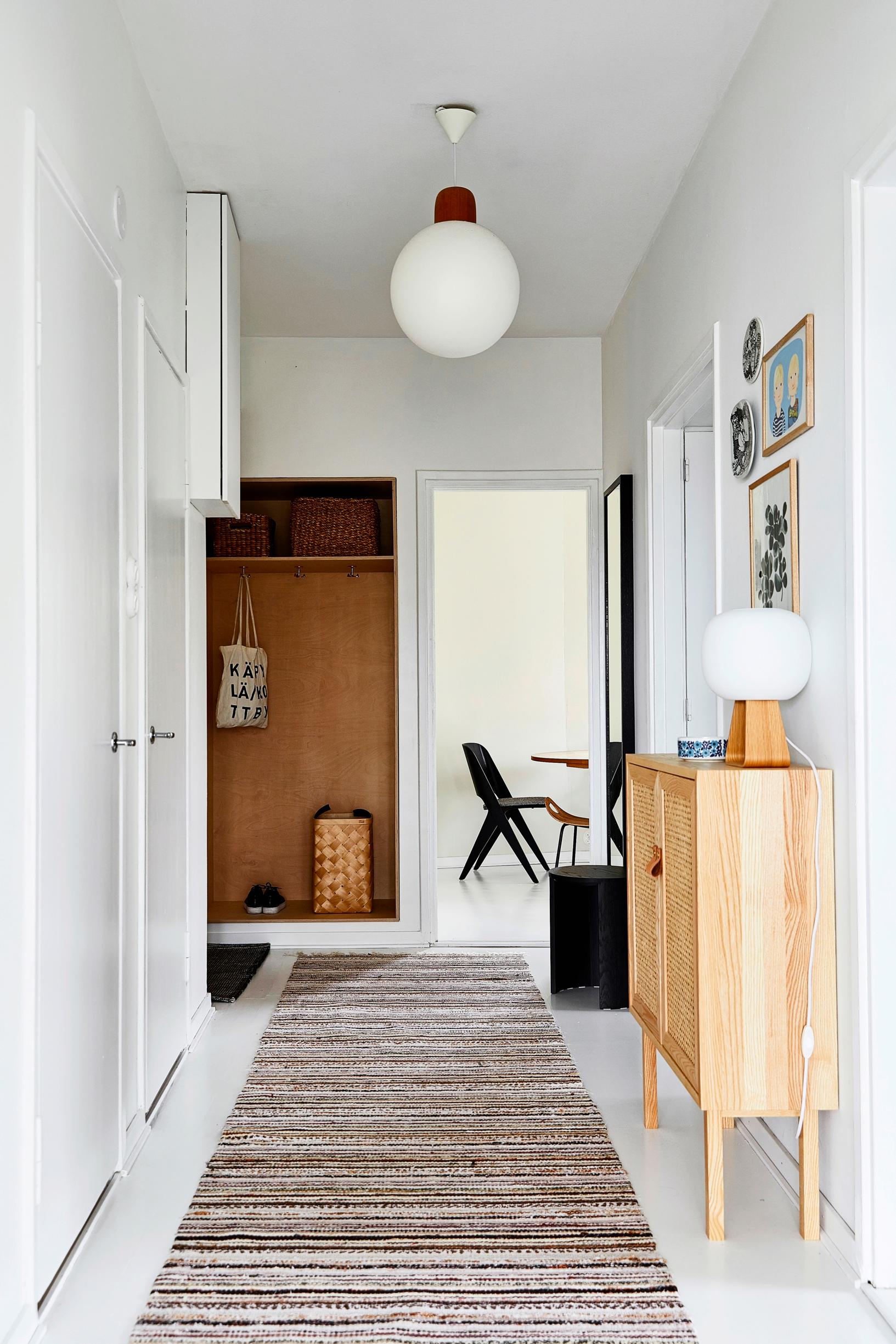 A long rag rug in the hallway leading to the entryway