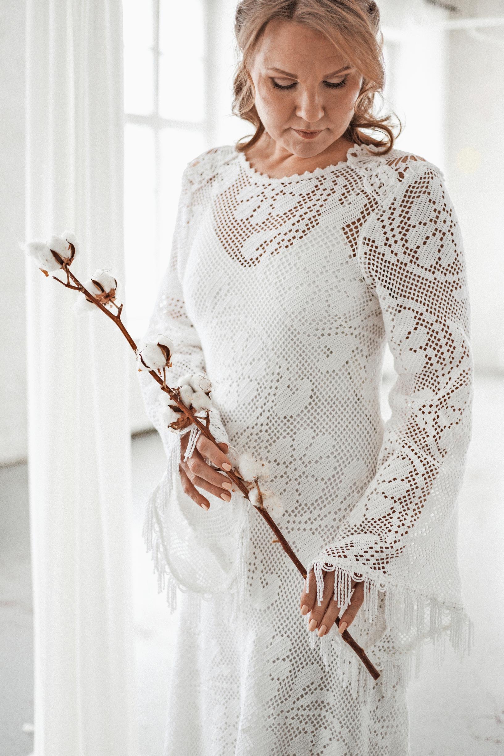 A lace wedding gown worn by a model.
