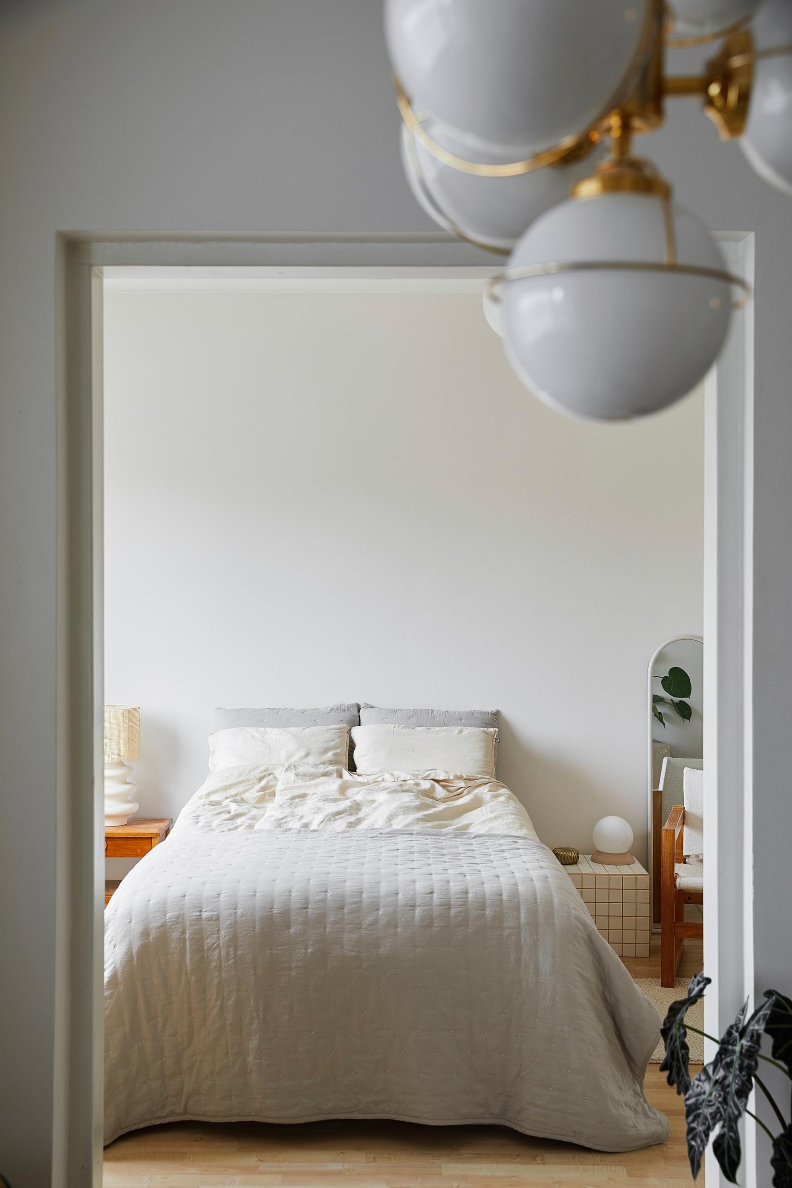 A self-made tiled table used as a bedside table