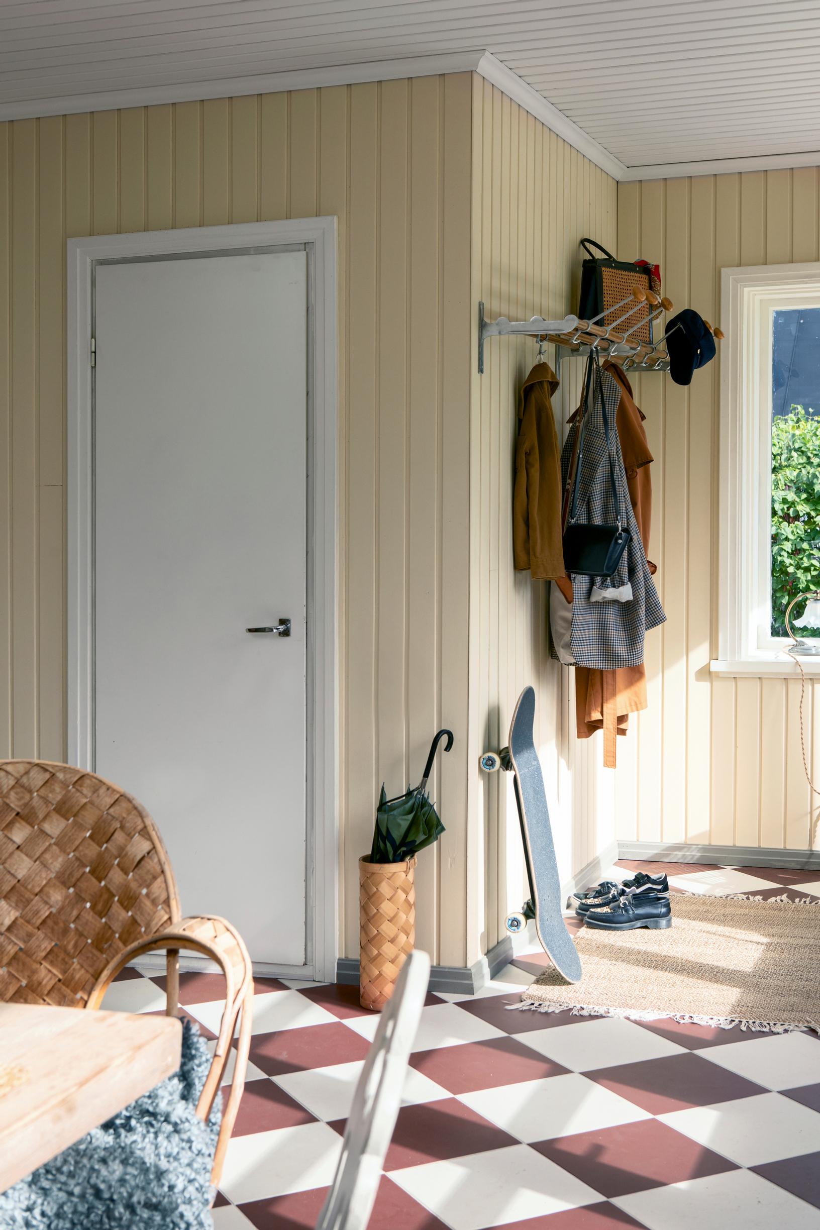 A wall-mounted coat rack with a hat shelf.