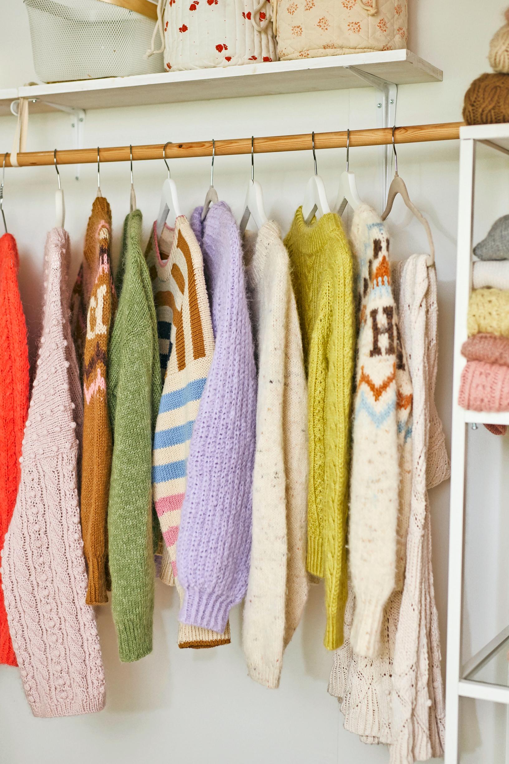 Veronika’s knitted garments on a rack.