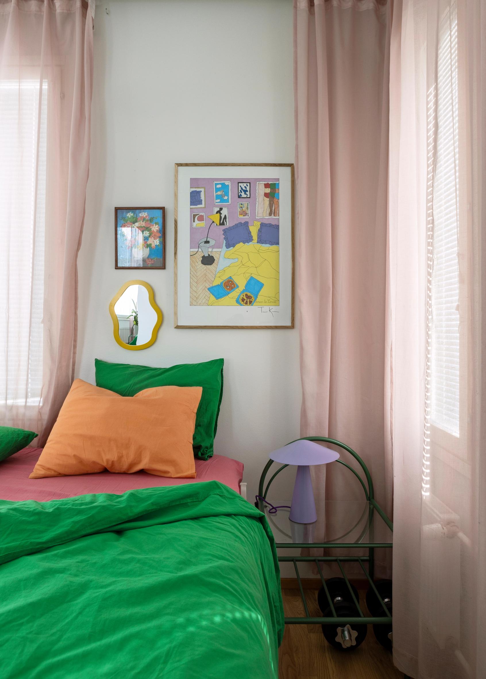 The bedroom has green bedding.