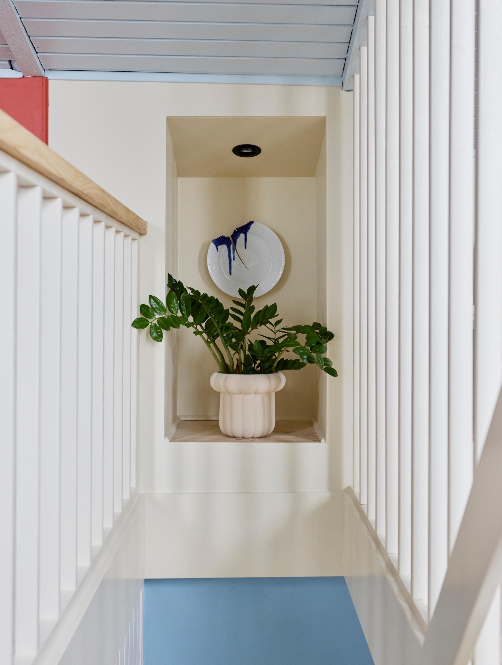 A unique art plate in the staircase recess.