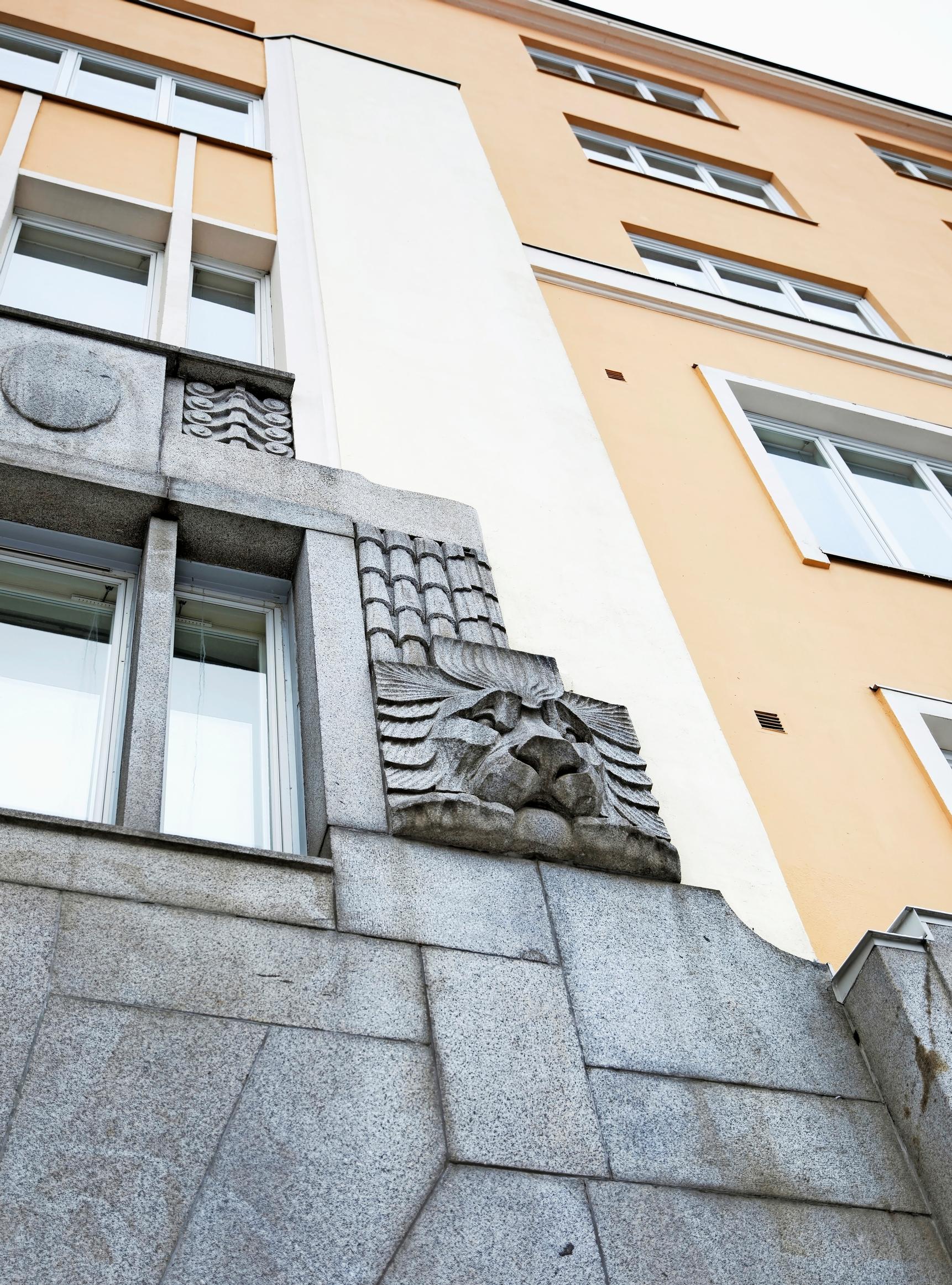 An old apartment building. A decorative lion relief.