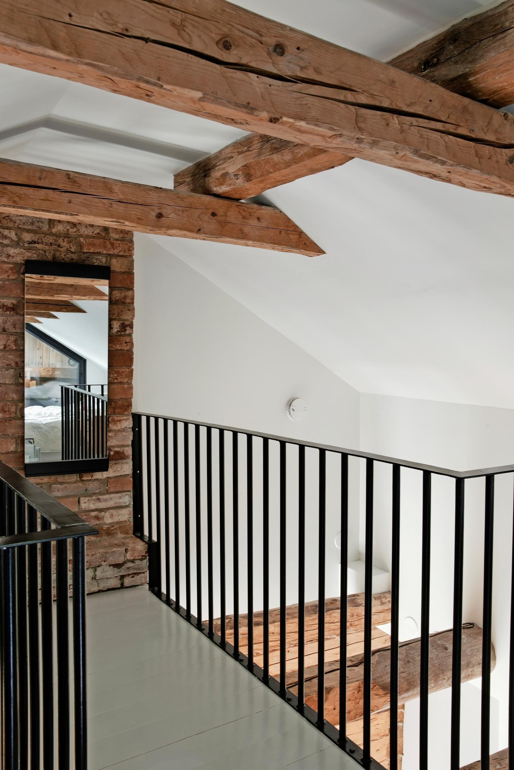 A walkway in the attic with metal railings on each side.