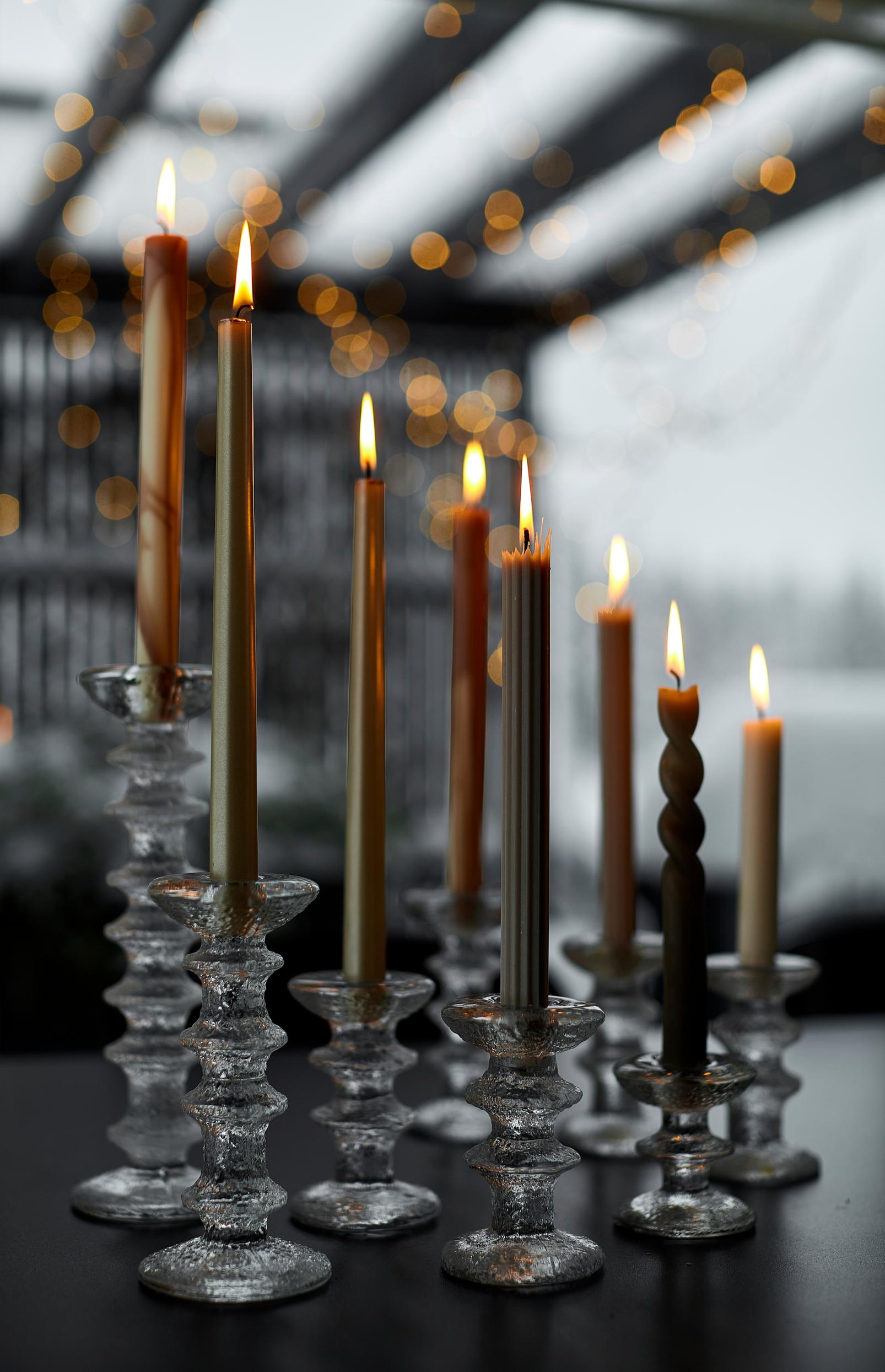 Ultima Thule candle holders in a row with candles lit