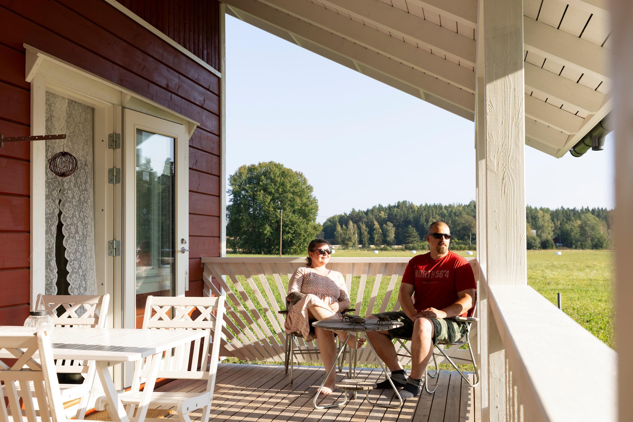 Tiia sits on the house’s terrace with her partner.