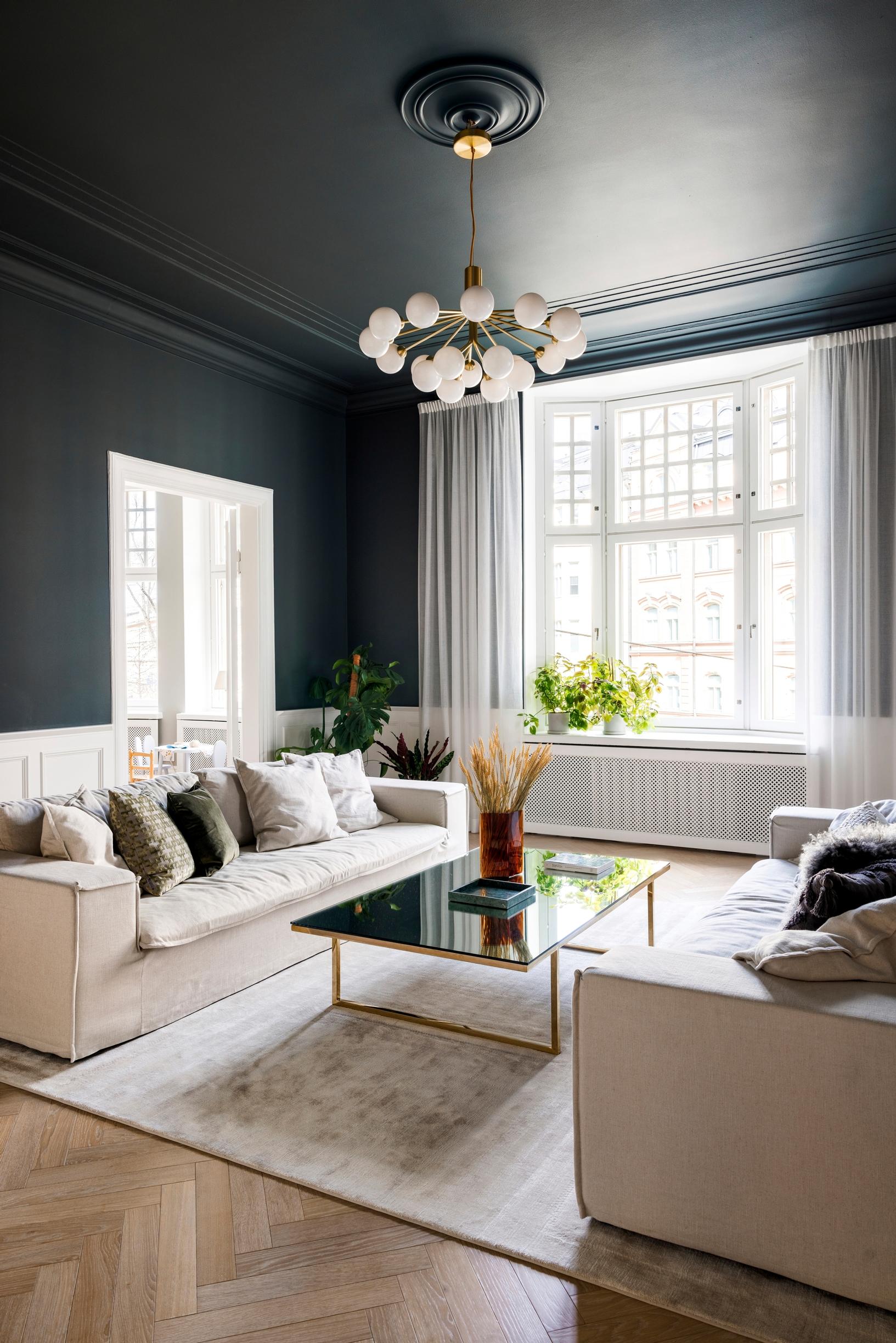 White sheer curtains in the bay window of a century-old city home