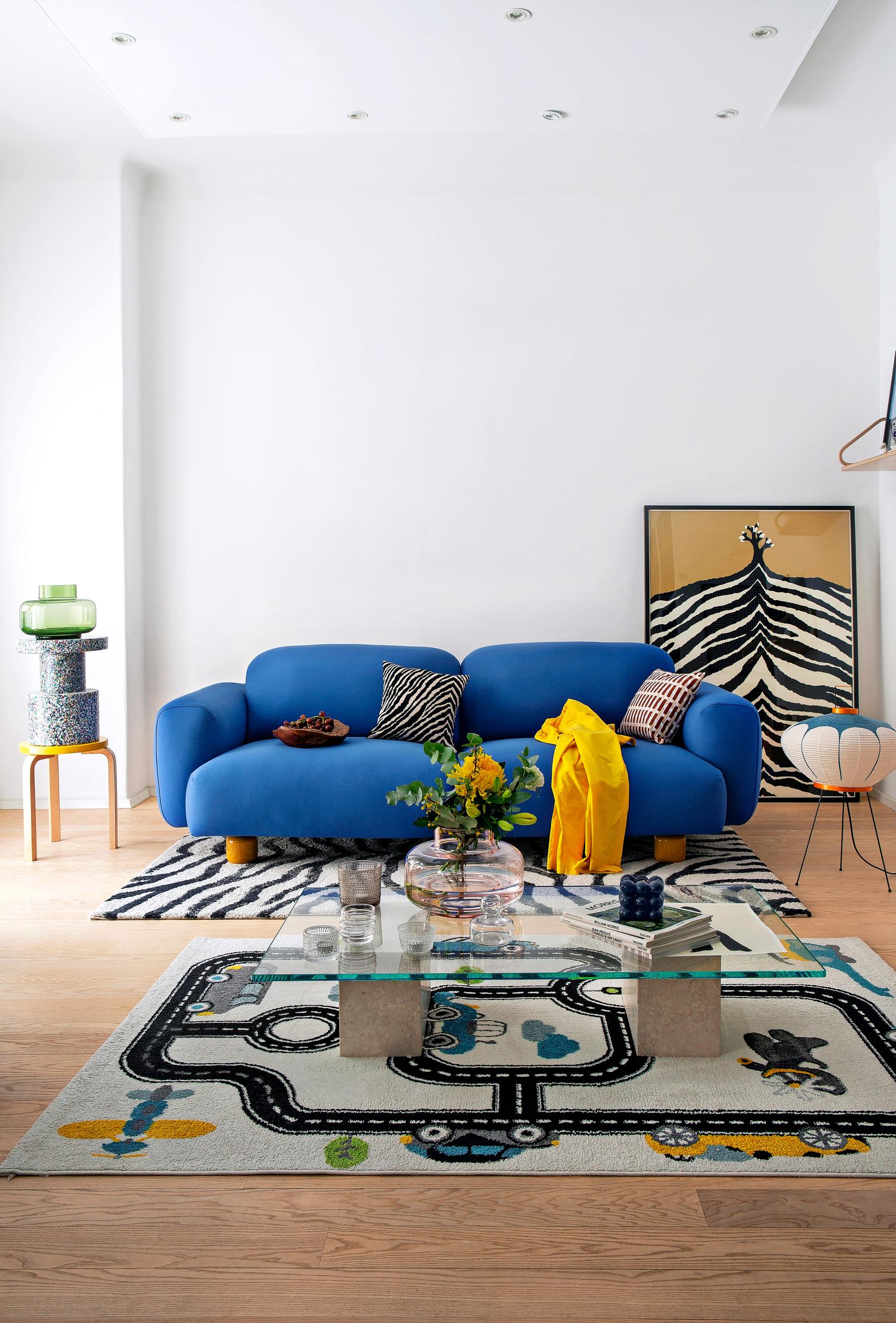 A plump cobalt-blue sofa