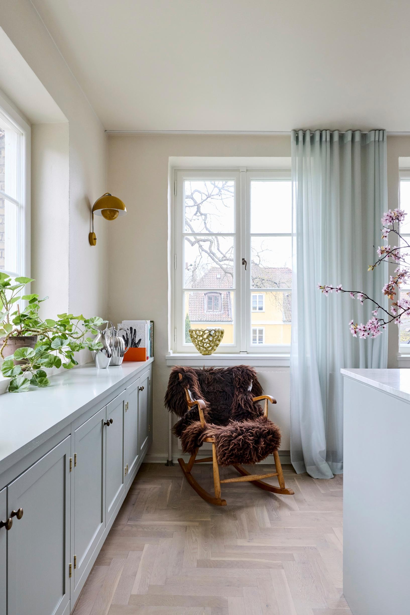 A rocking chair in the mint-green kitchen