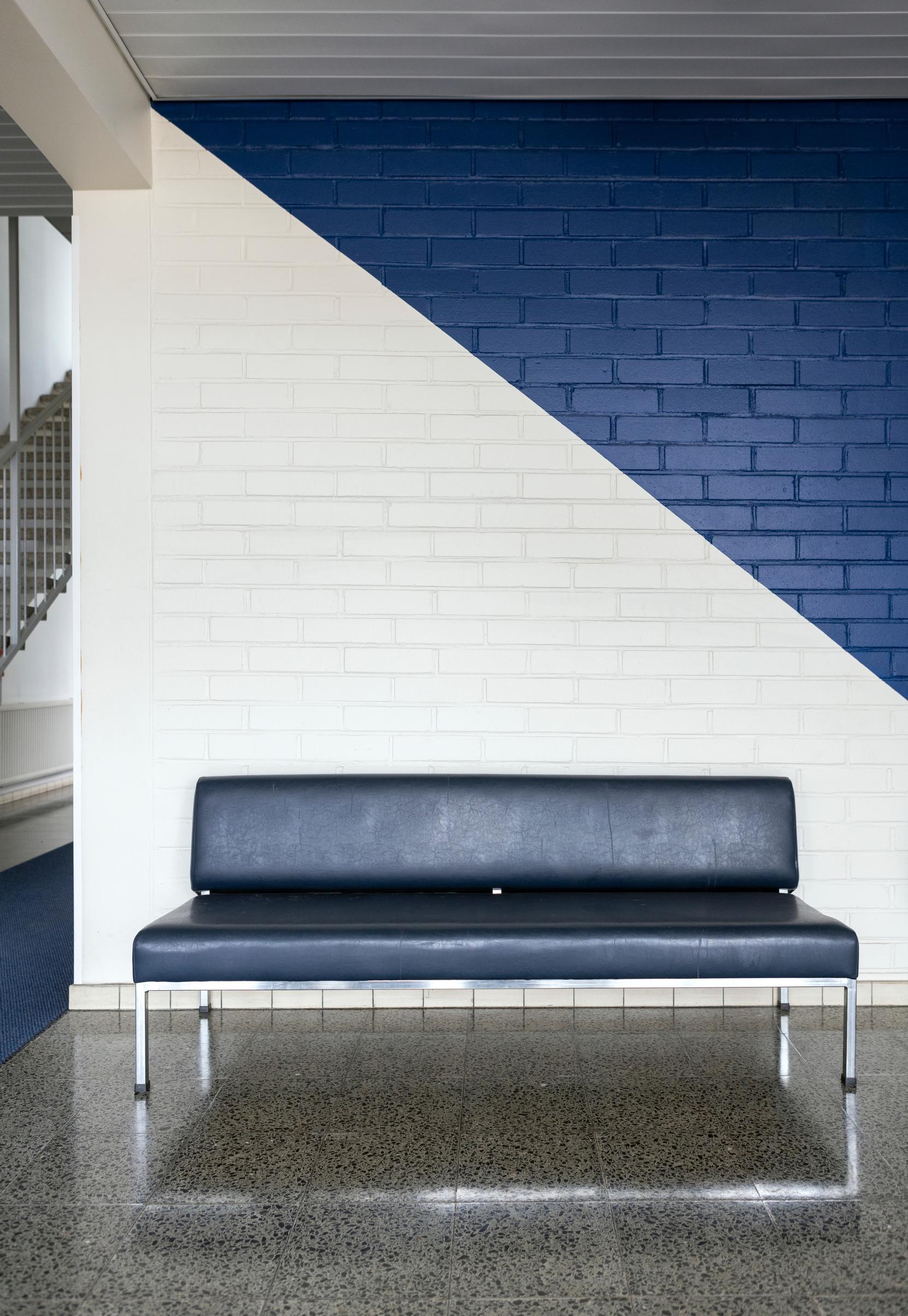 A blue bench in the stairwell