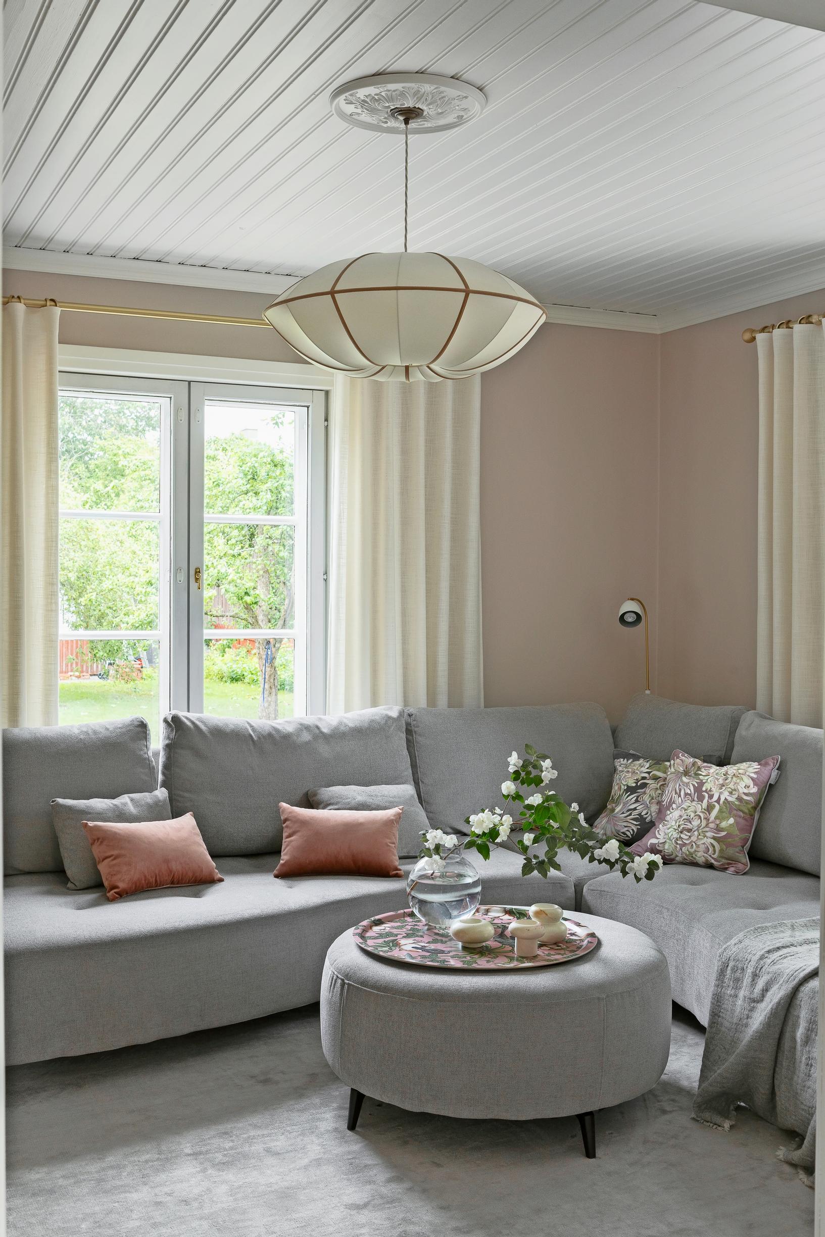 a gray corner sofa and ottoman