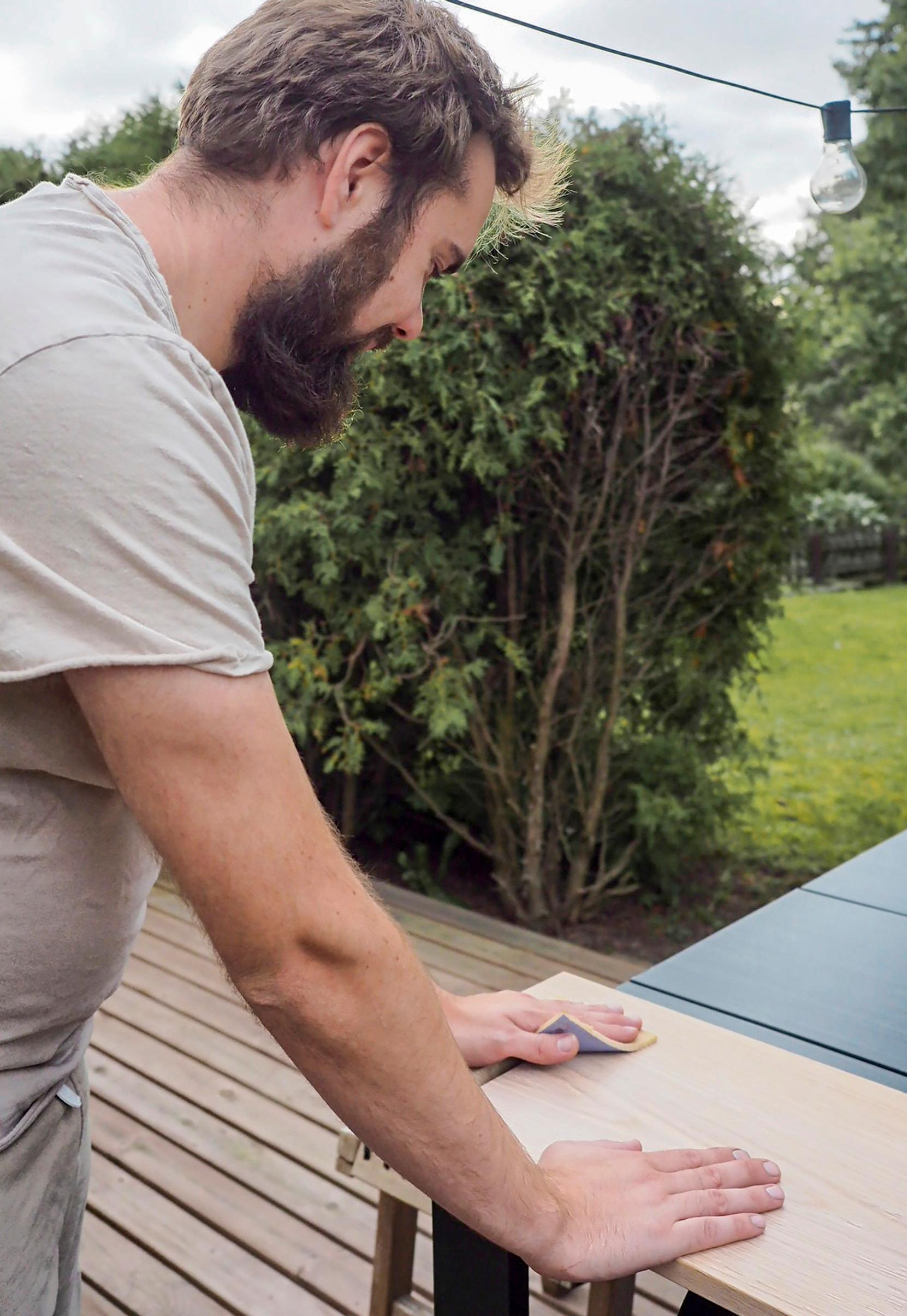 Sanding the shelf boards’ joint areas.