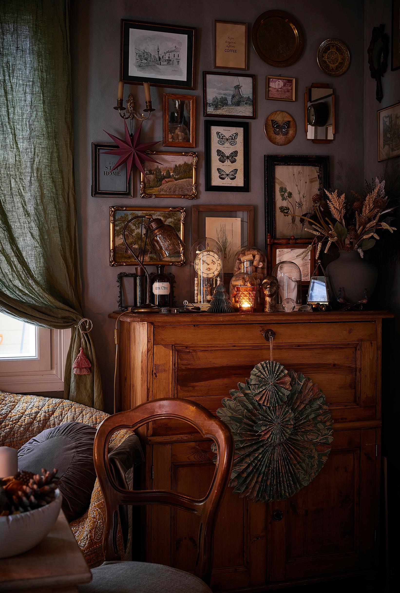 On the back room wall, framed pictures and paintings from flea markets.