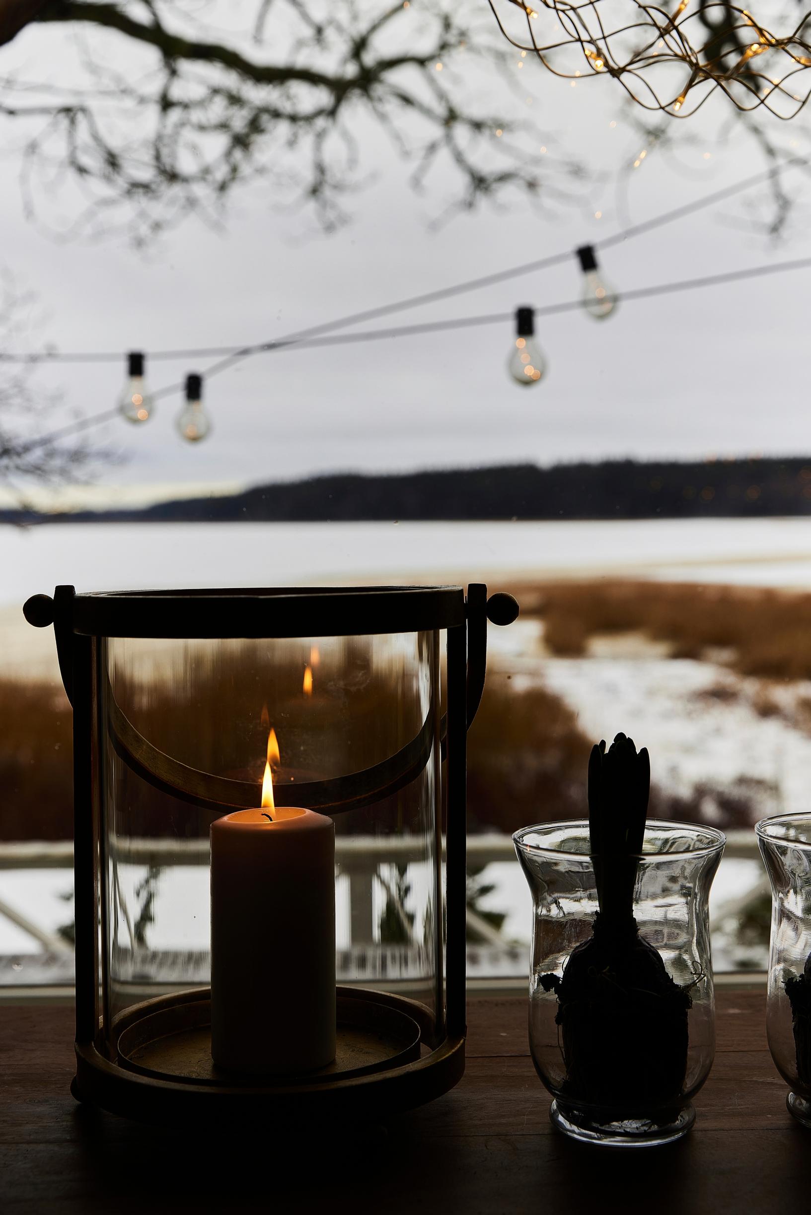 Candle and a hyacinth on the windowsill