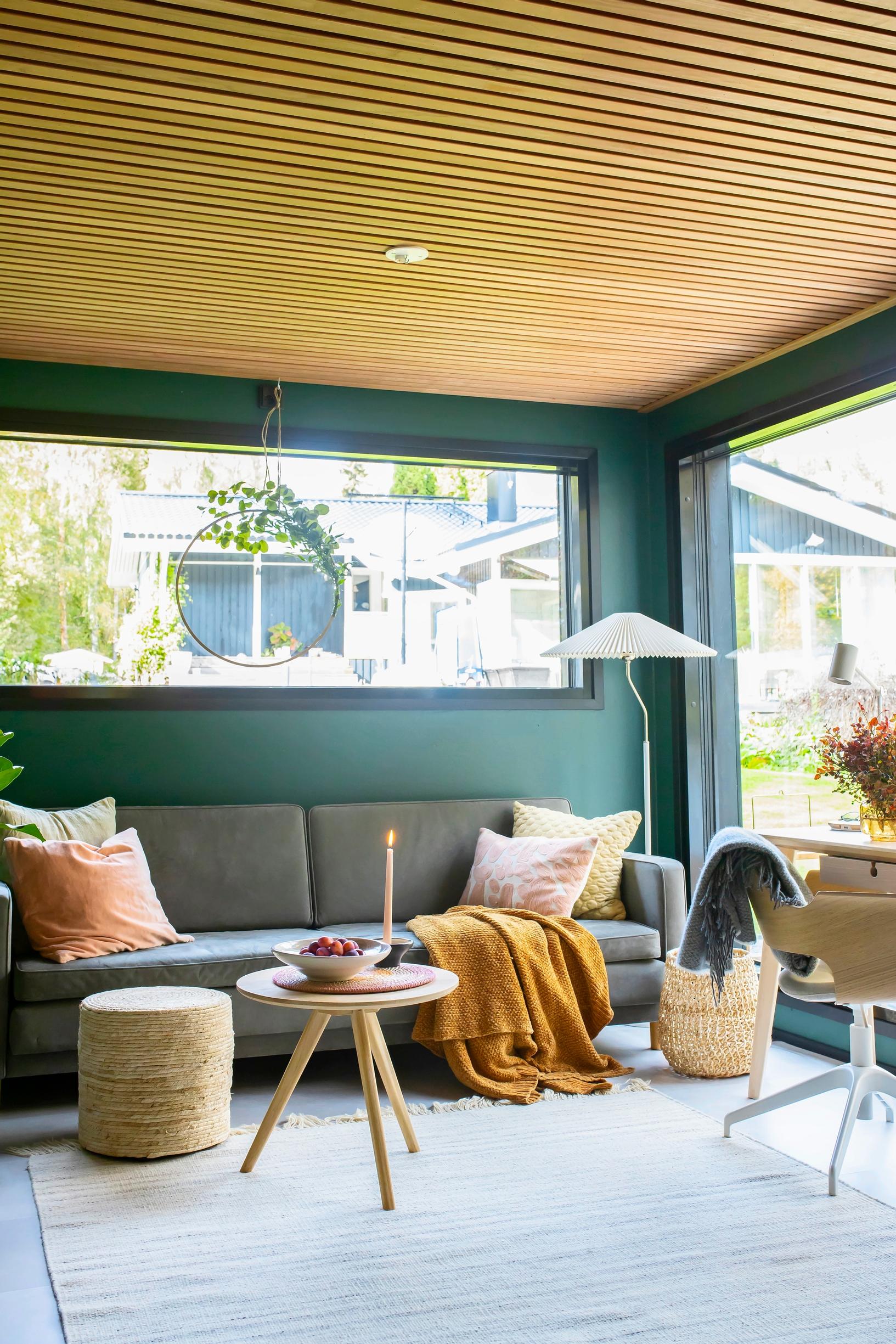 The sauna cottage living area with a green wall