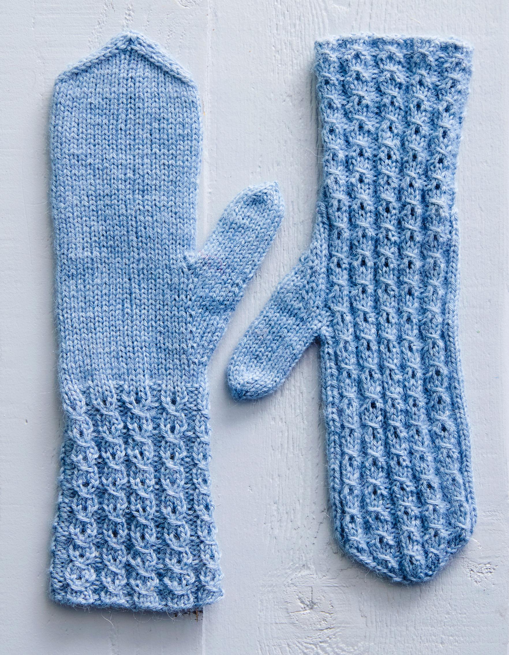 Mock cable mittens on a surface