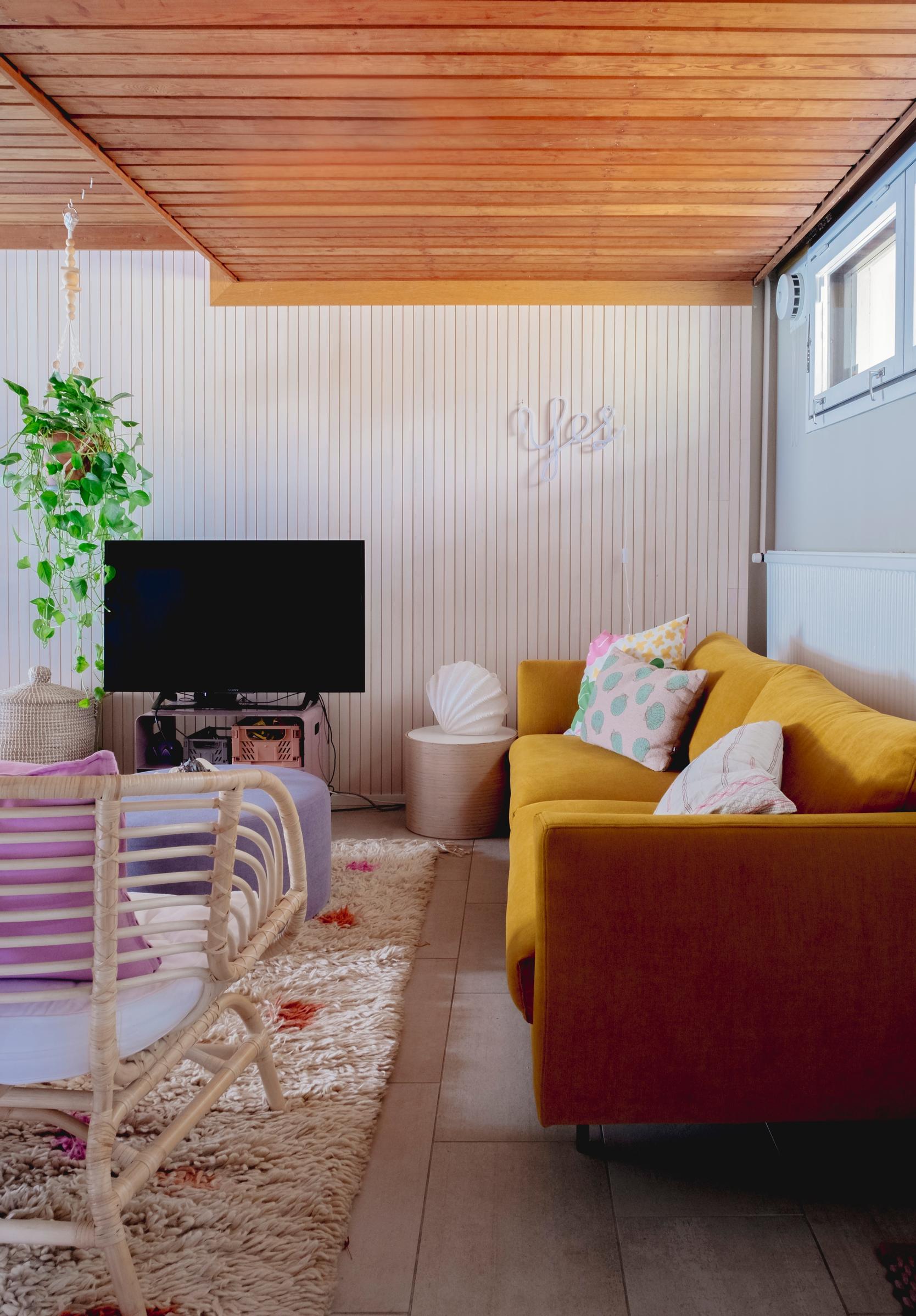 A relaxed downstairs area with a sofa and TV