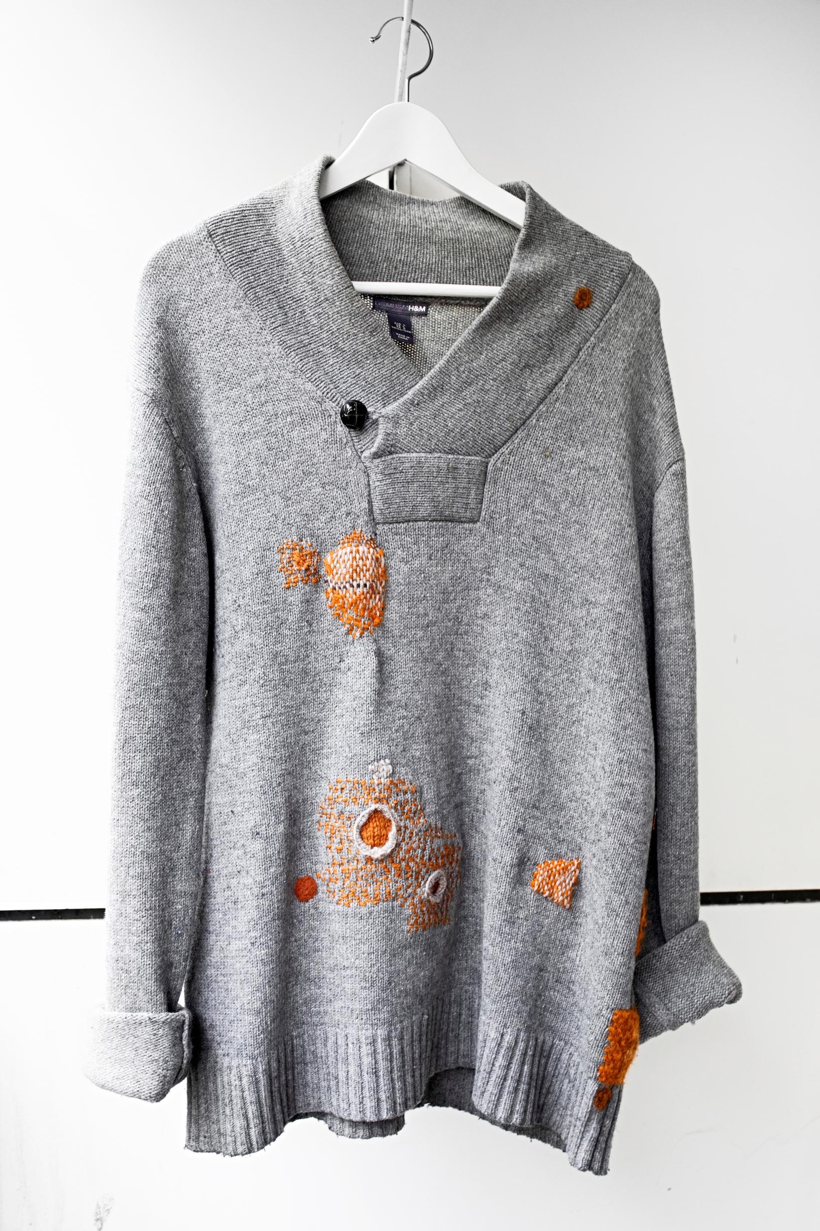 A repaired gray sweater