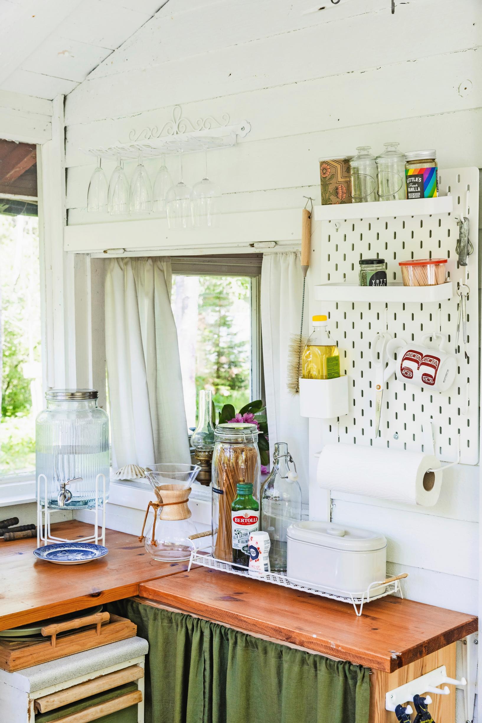 various items hanging from a wall rack in the kitchen