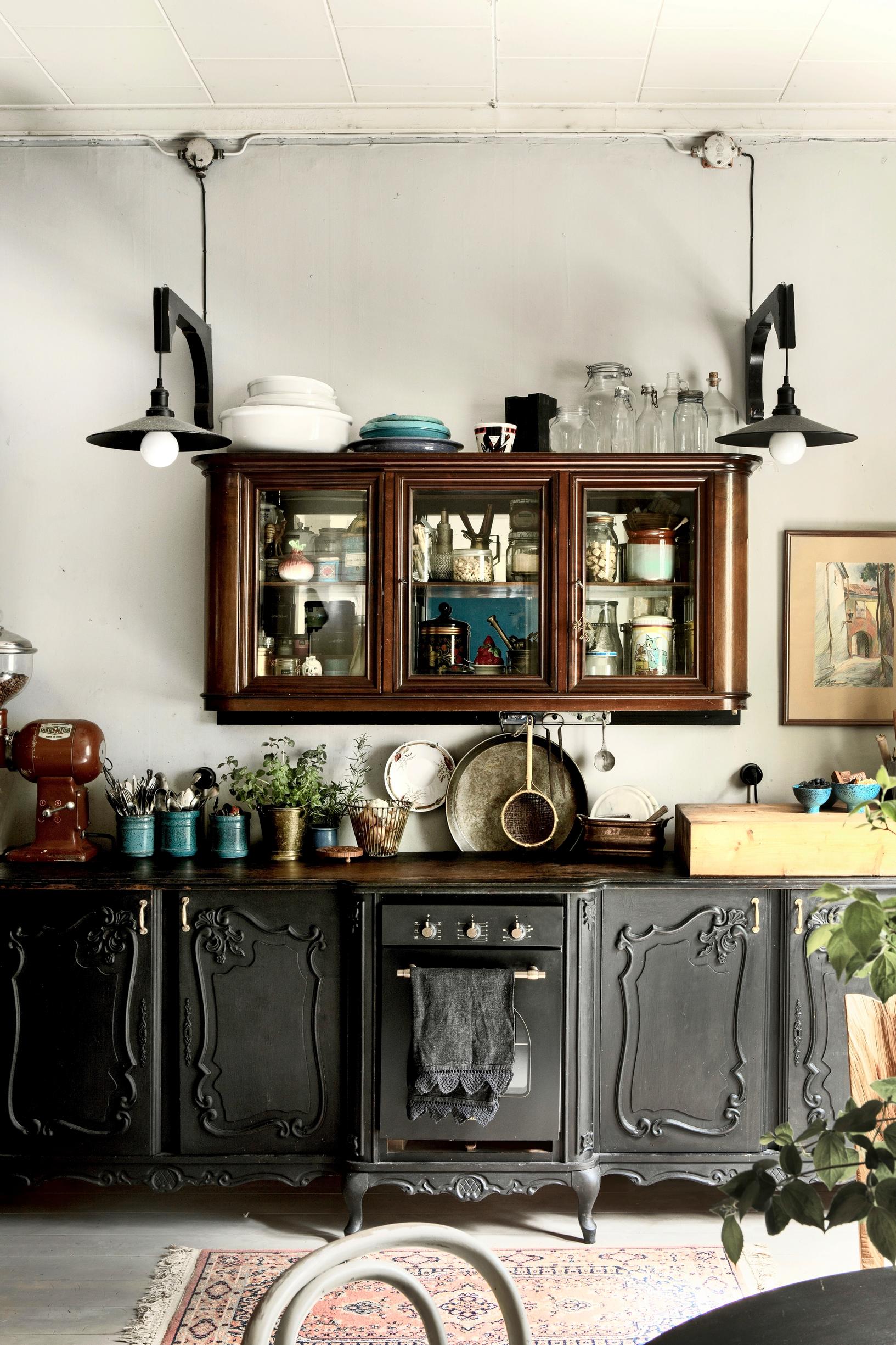 The refurbished lower kitchen cabinets are painted black.