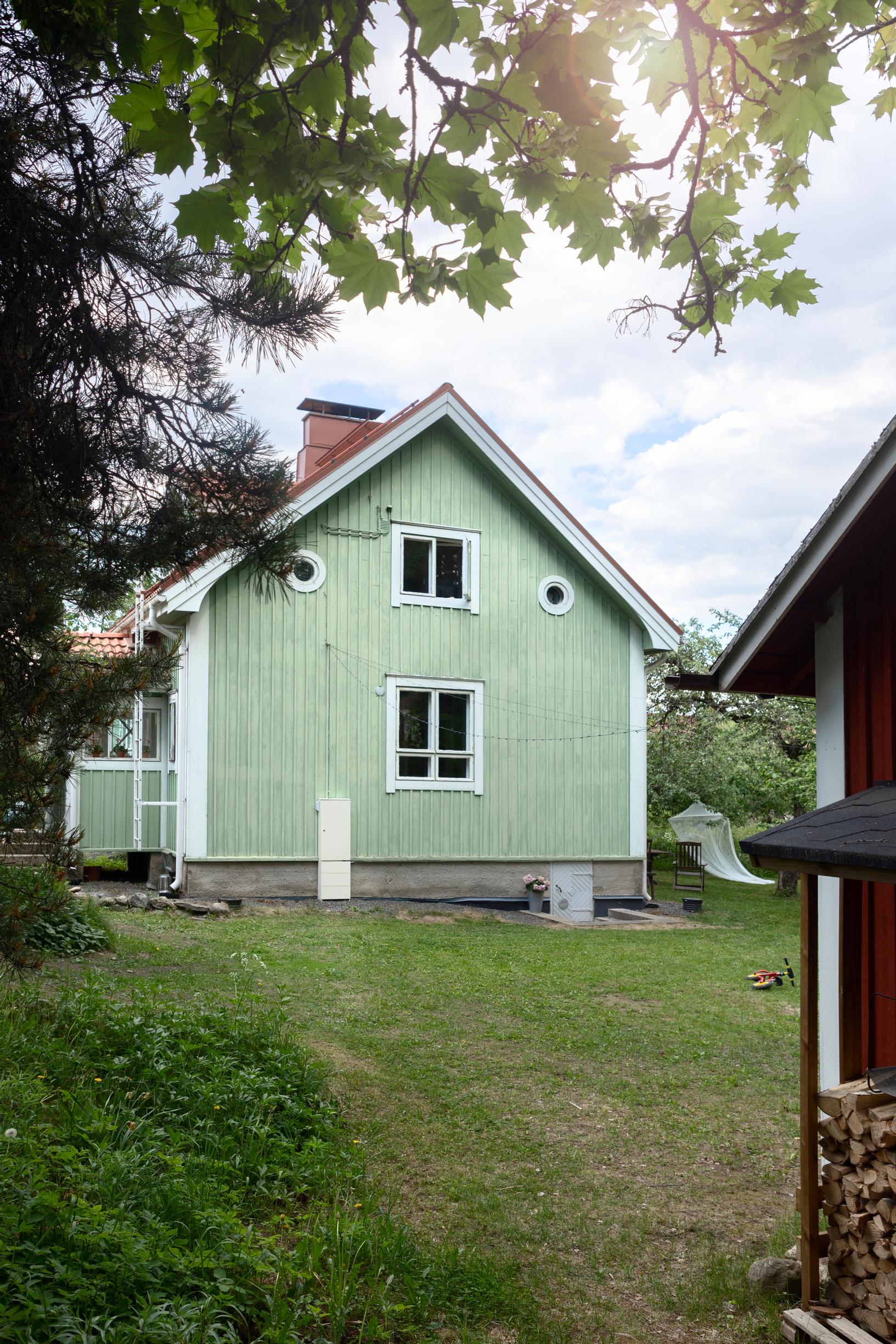 Green wooden house and yard