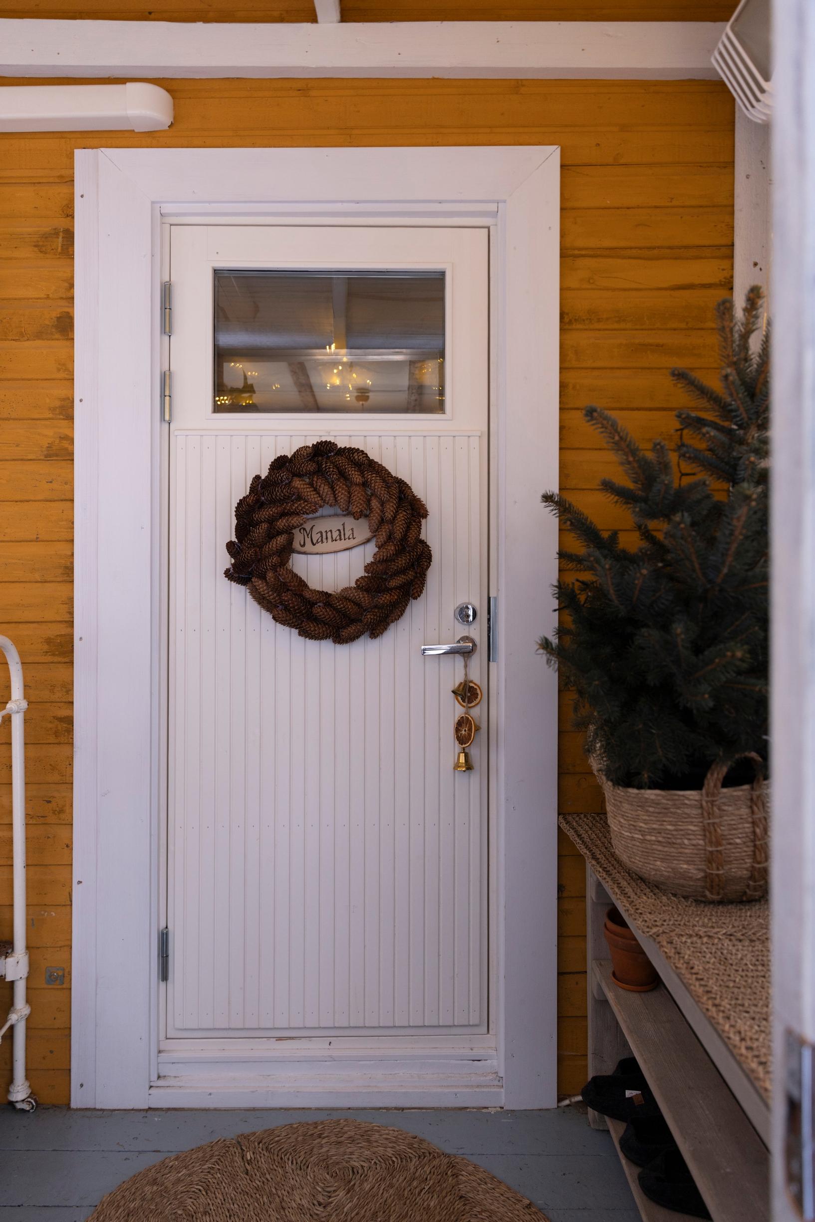 A door with a pinecone wreath