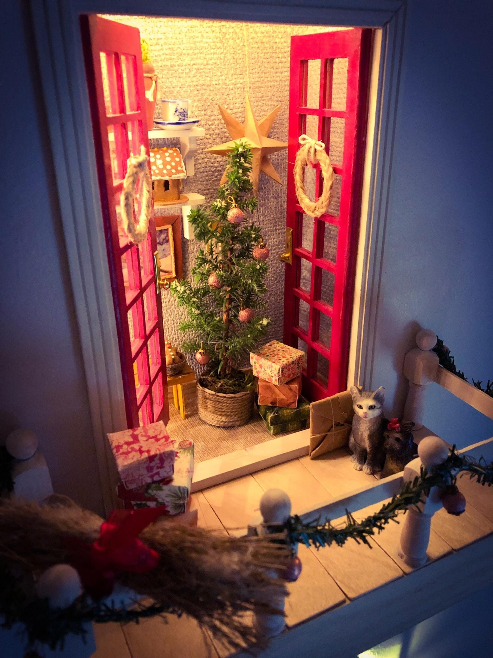 A Christmas tree behind the elf balcony doors