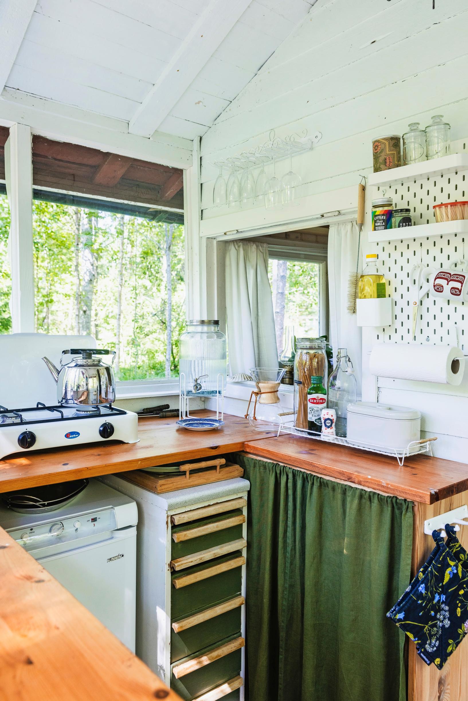 a kitchen area with a stovetop and fridge