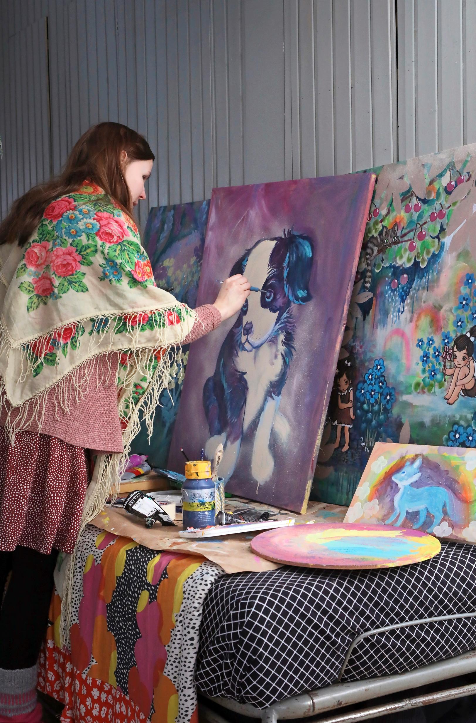 Leena Rissa painting a picture.