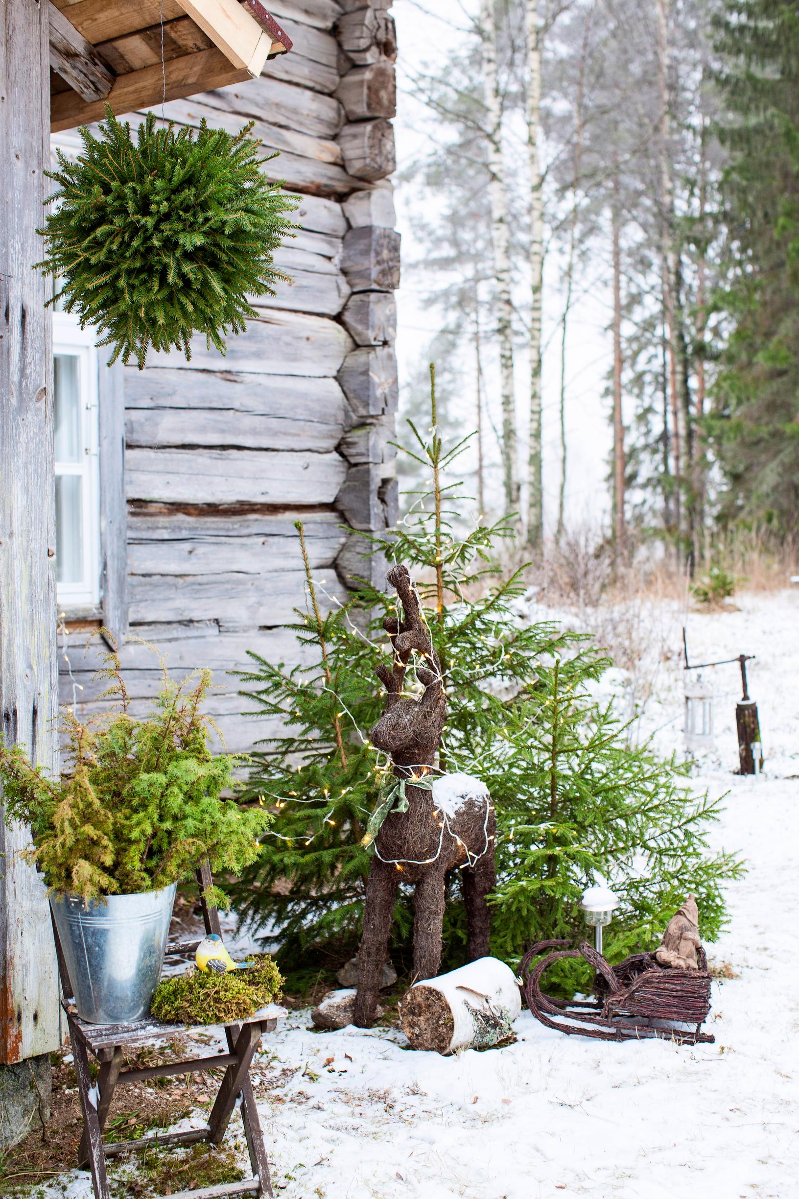 Evergreen decorations outside a cabin